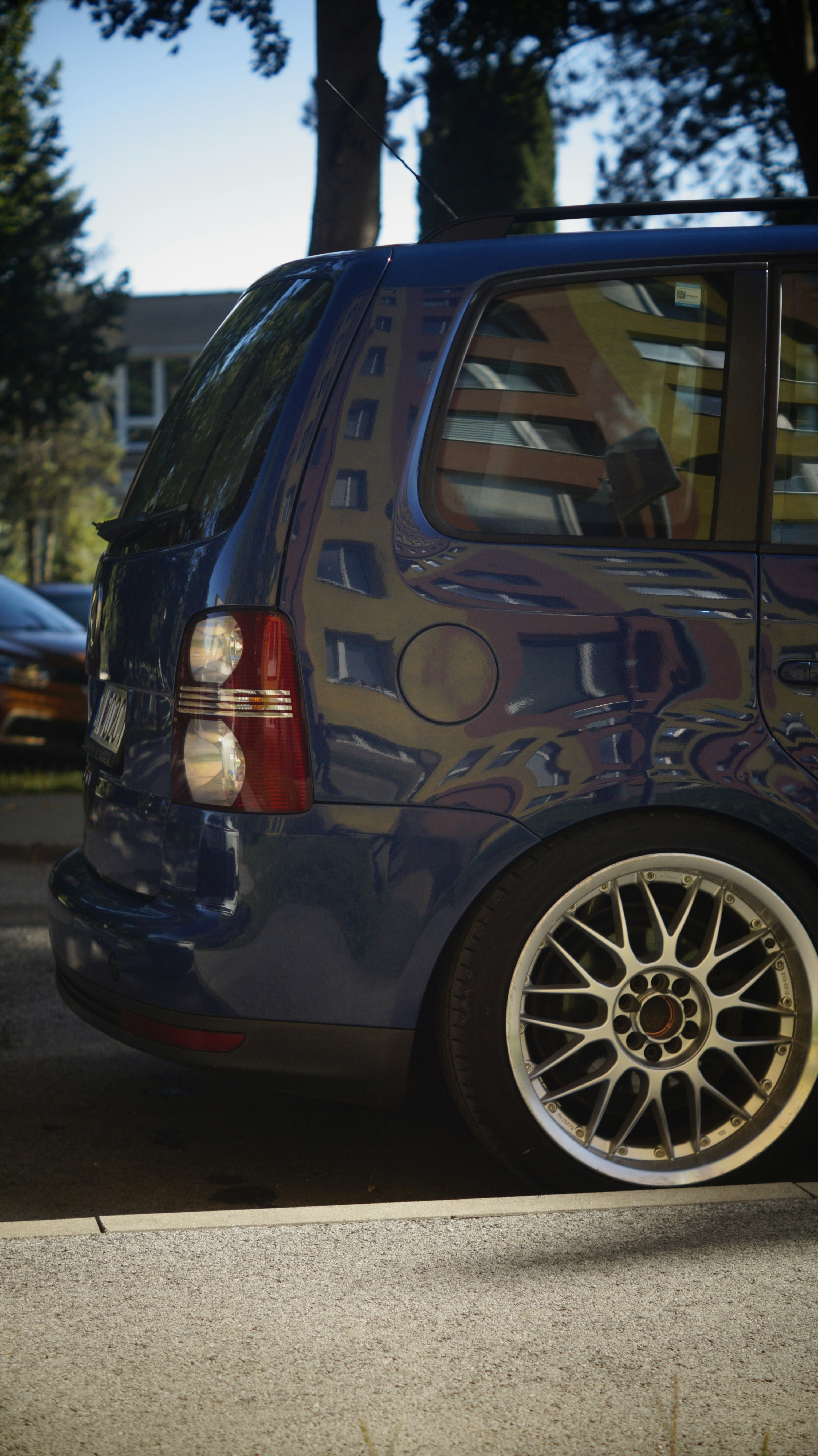 A small blue car parked on the side of the road