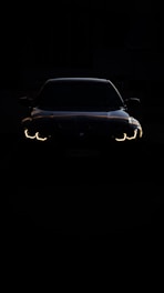 A car in the dark with its headlights on