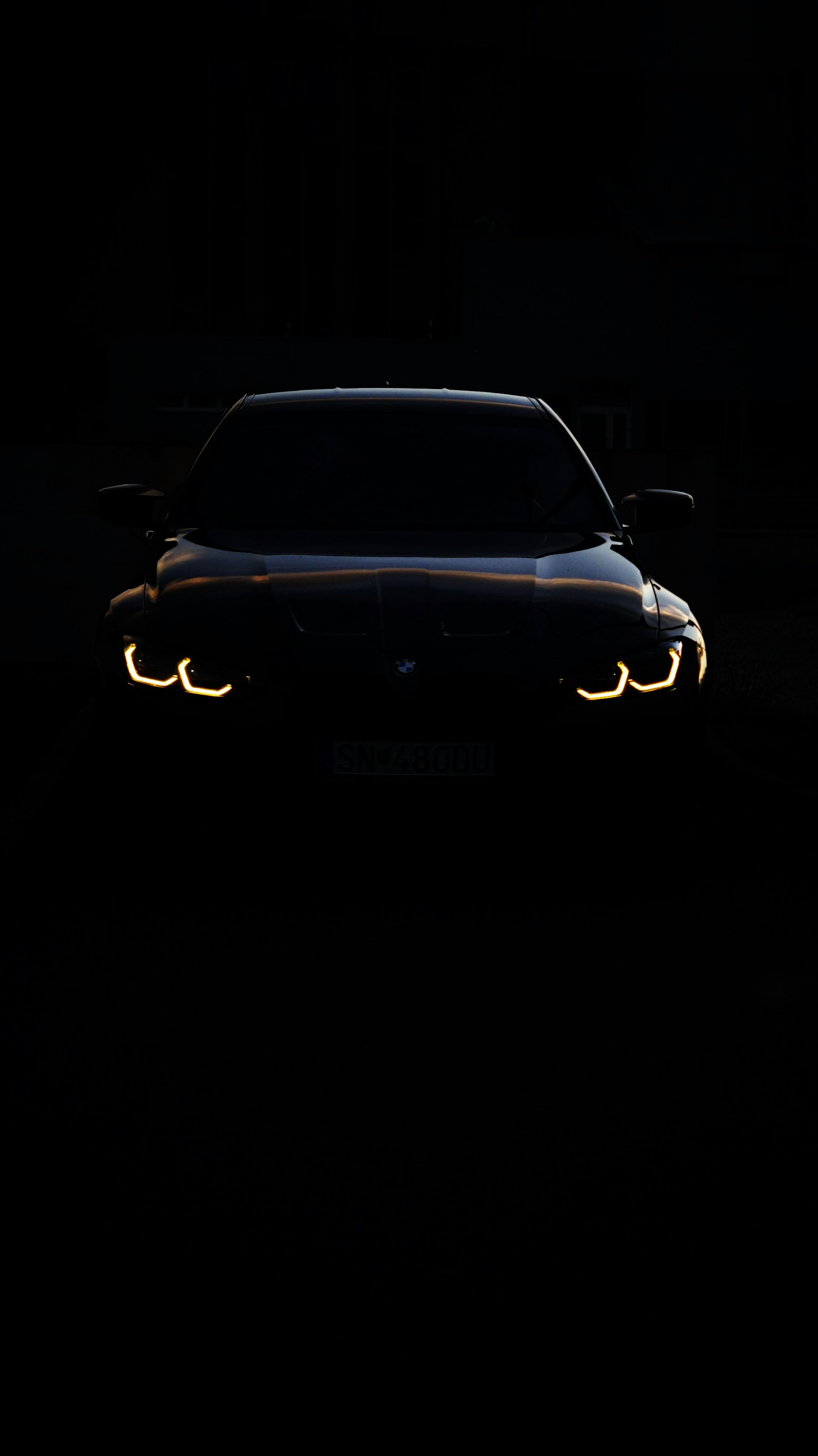 A car in the dark with its headlights on