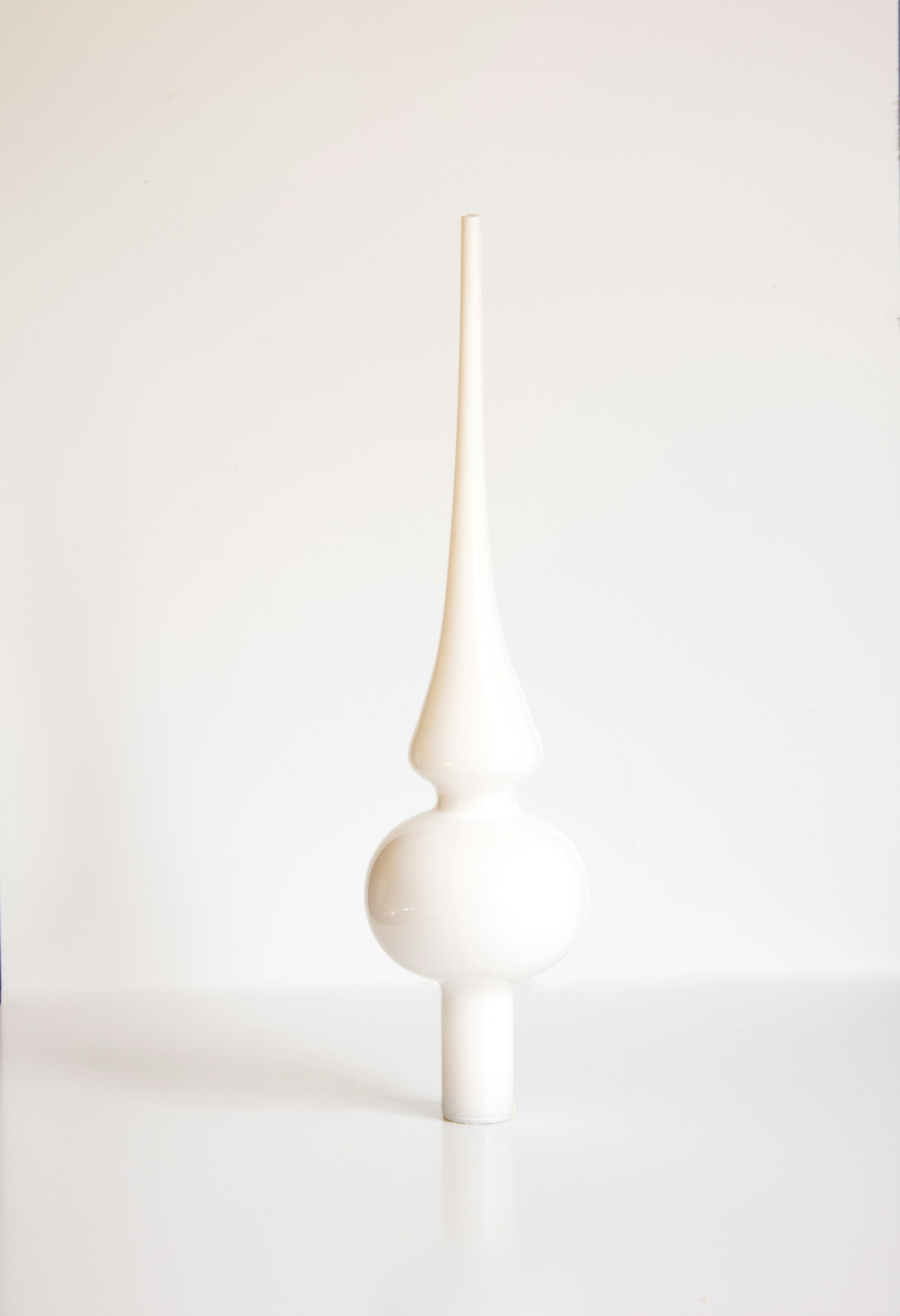 A white vase sitting on top of a table