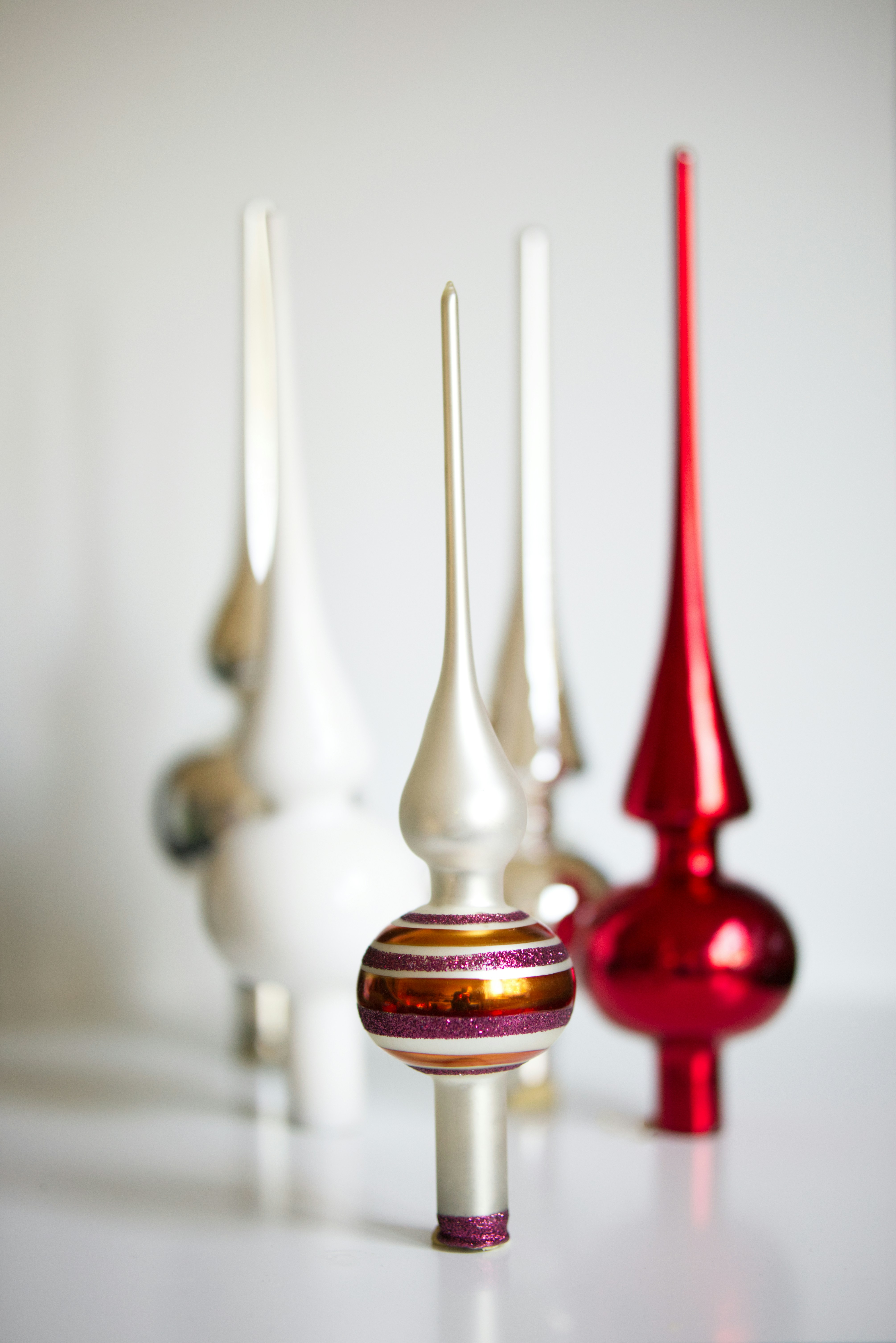 A group of different colored vases sitting on a table