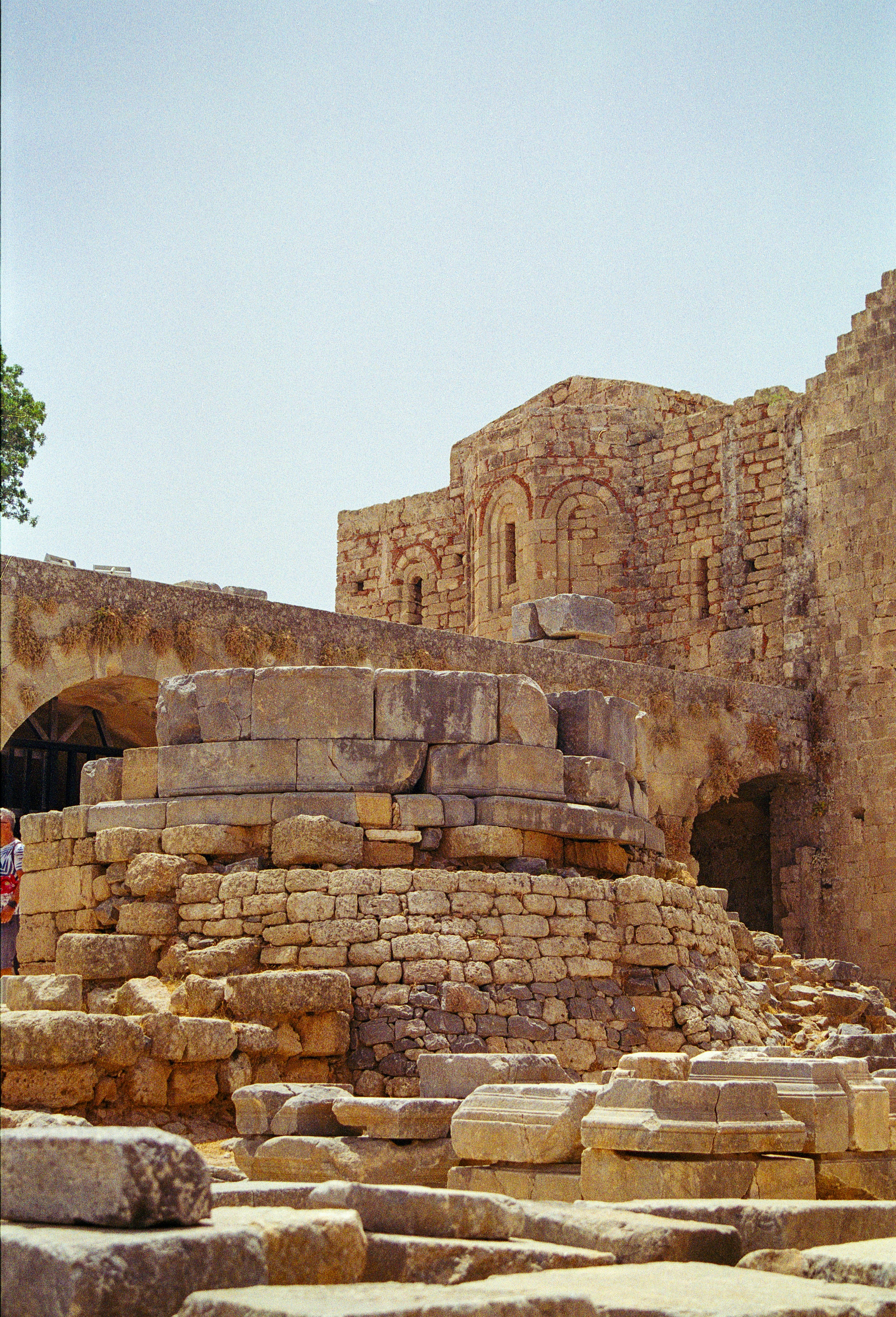 A stone building with a clock tower in the middle of it