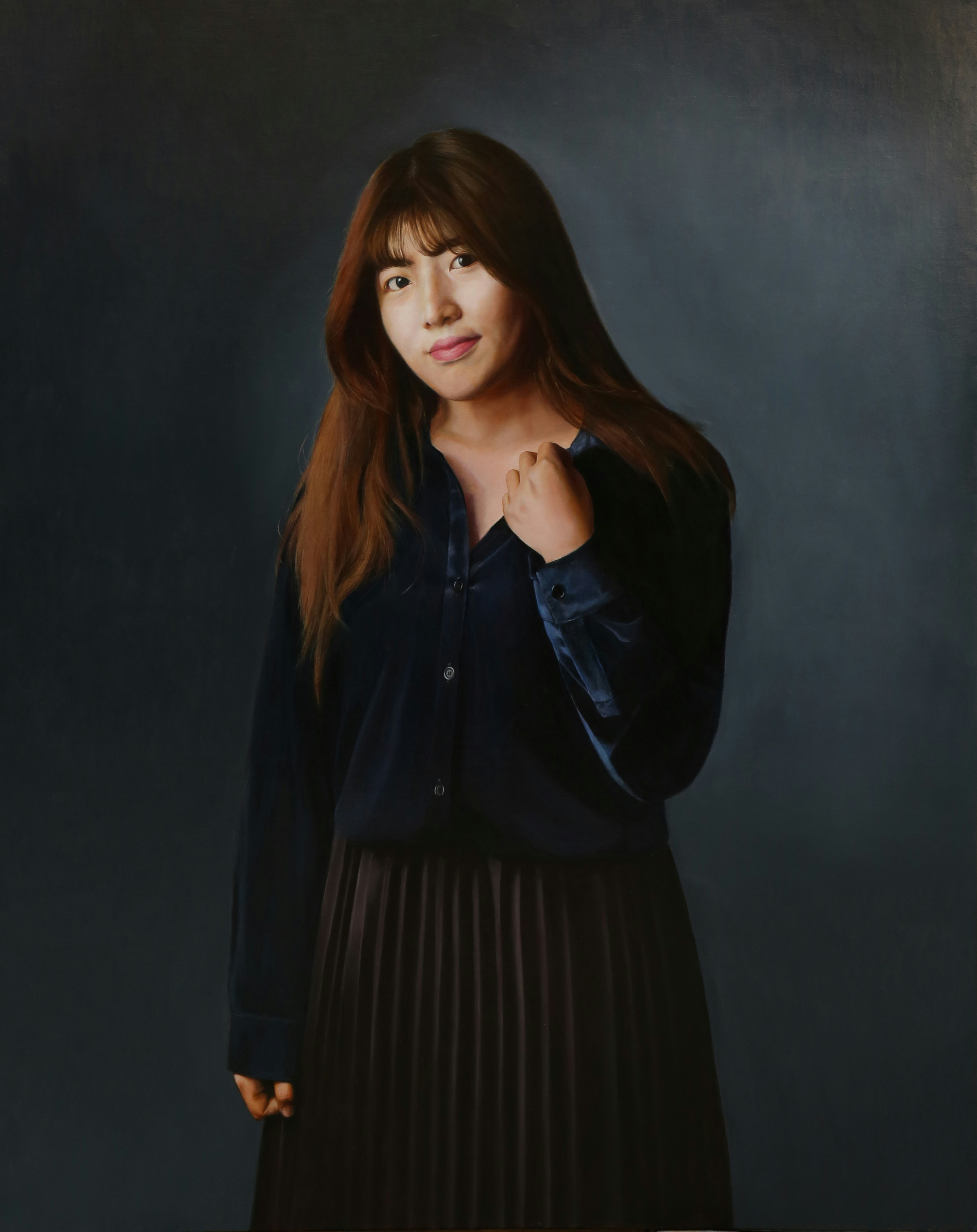 A woman standing in front of a picture of herself