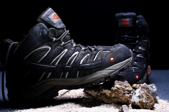 A pair of hiking shoes sitting on top of a rock