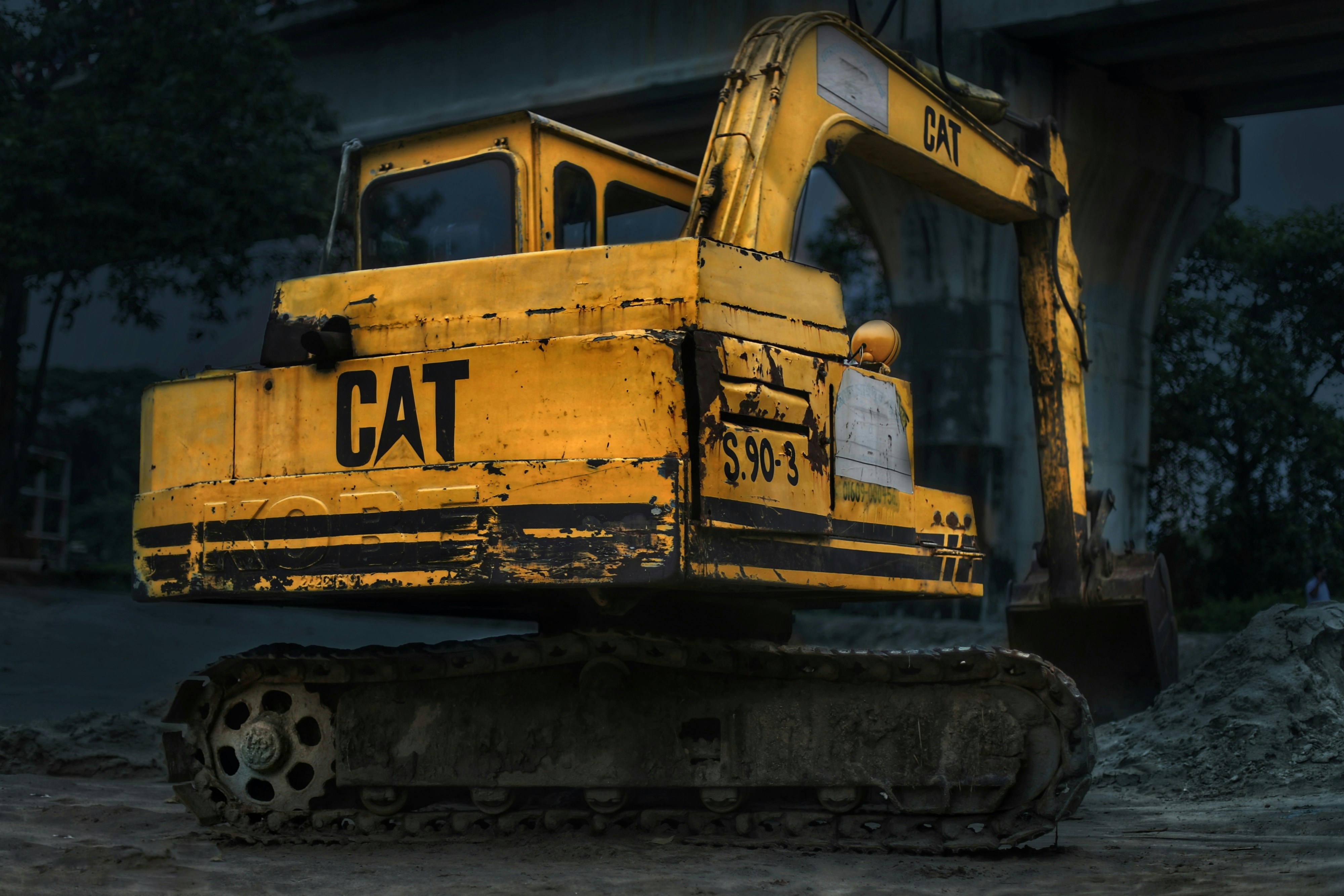 A large yellow bulldozer sitting on top of a dirt field