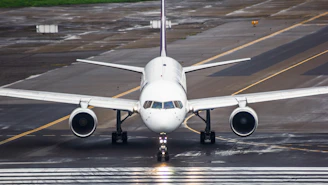 A large jetliner sitting on top of an airport runway