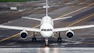 A large jetliner sitting on top of an airport runway