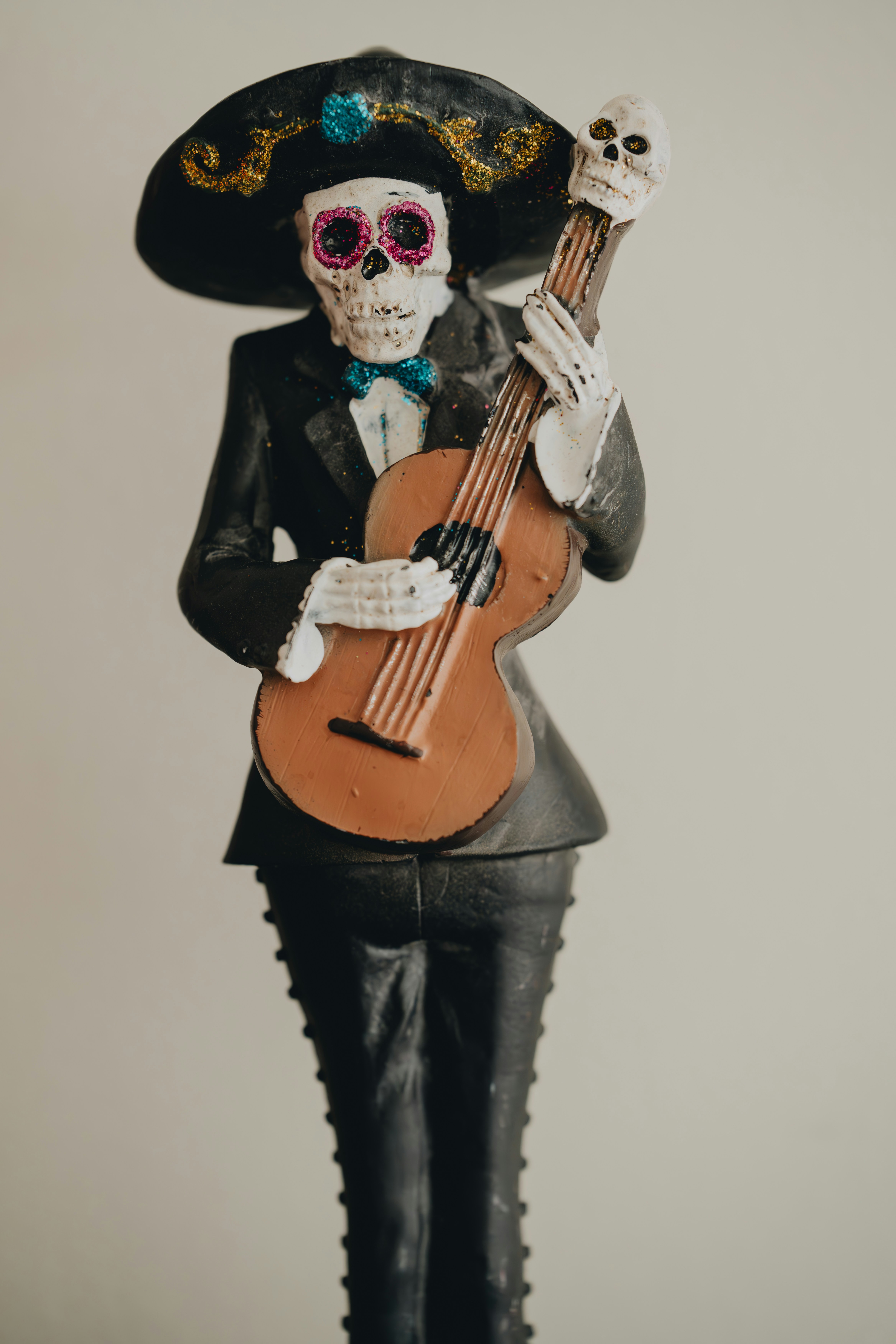 A statue of a skeleton holding a guitar