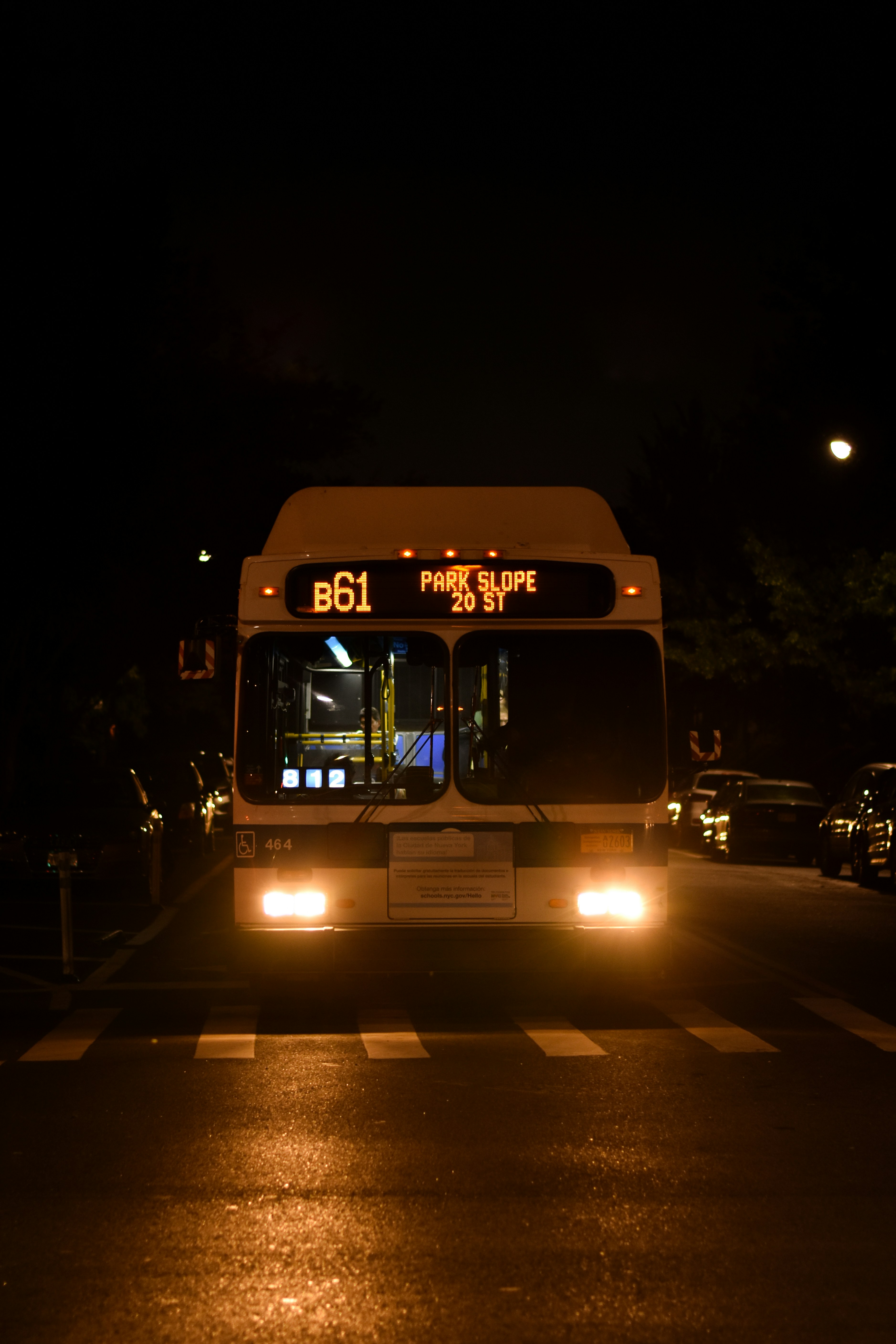 A bus driving down a street at night