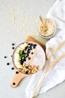 A bowl of oatmeal with blueberries and bananas