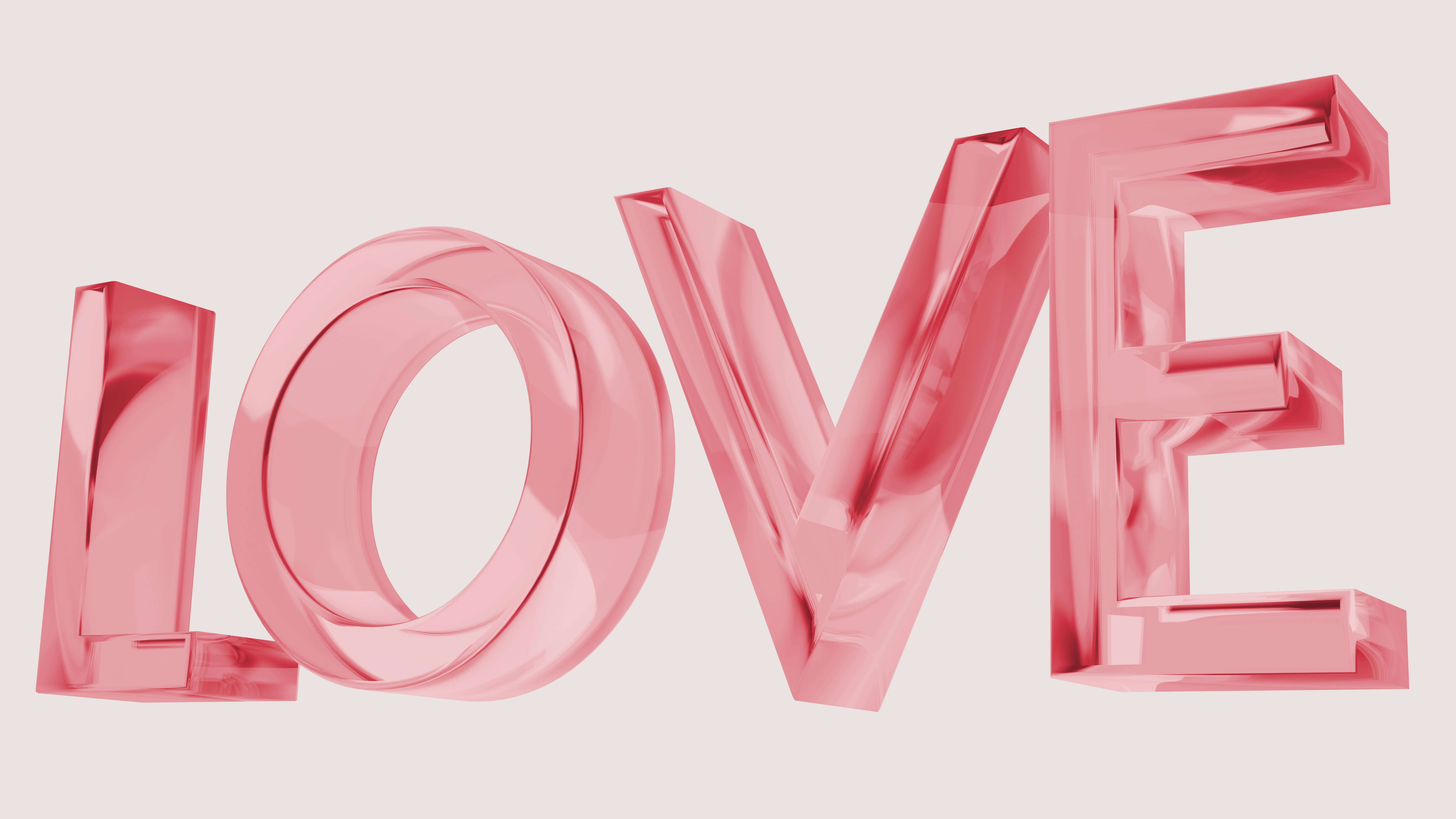 The word love is made up of shiny pink letters
