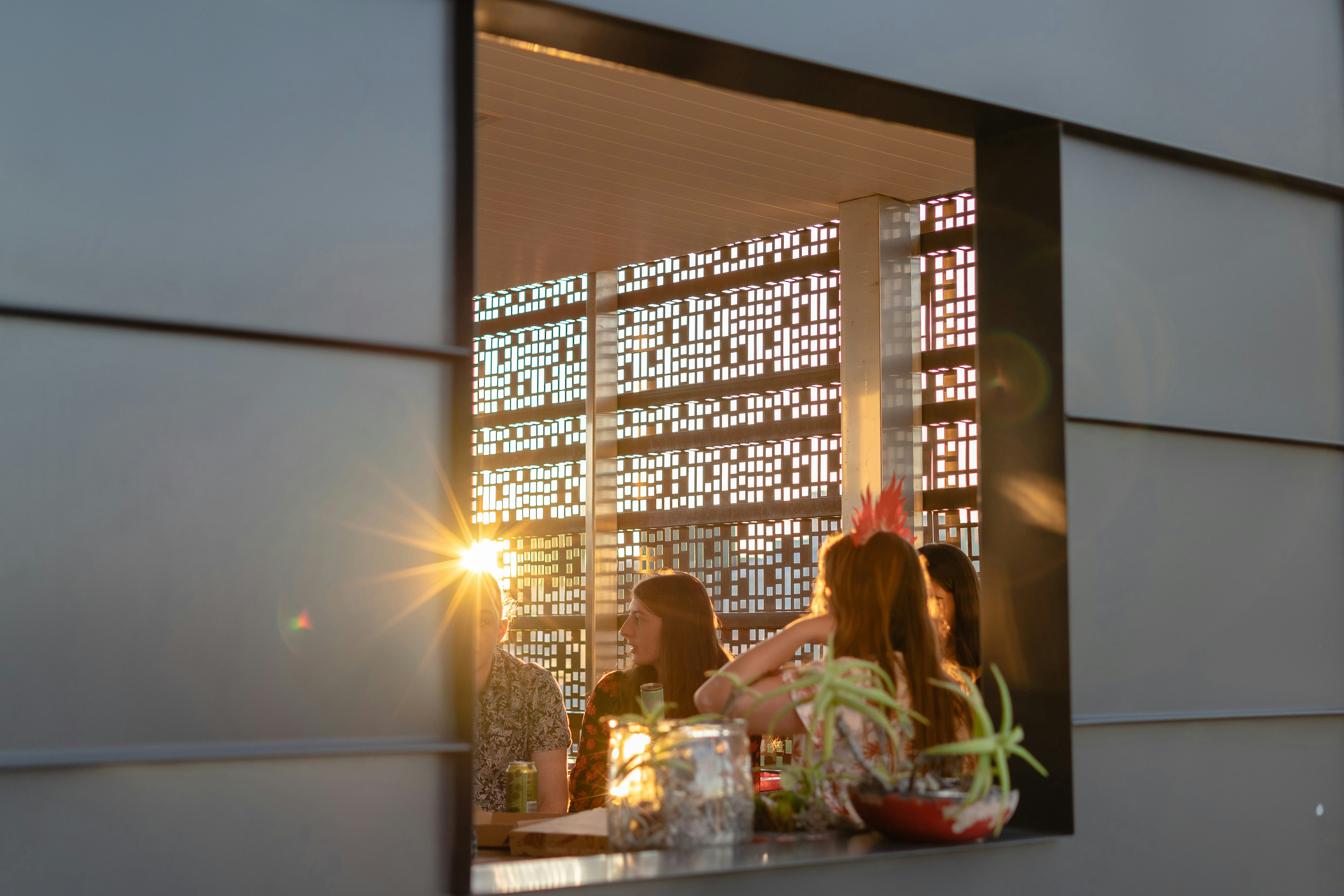 A couple of people sitting at a table in front of a window
