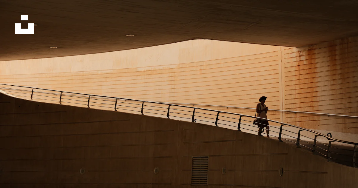A person walking up a ramp in a building photo – Free Street ...