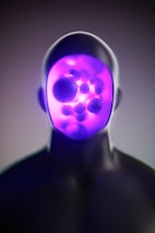 A man with a purple light on his face