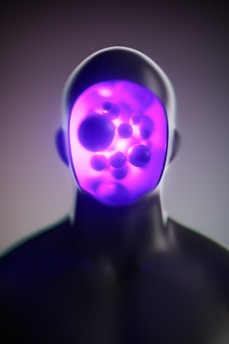 A man with a purple light on his face