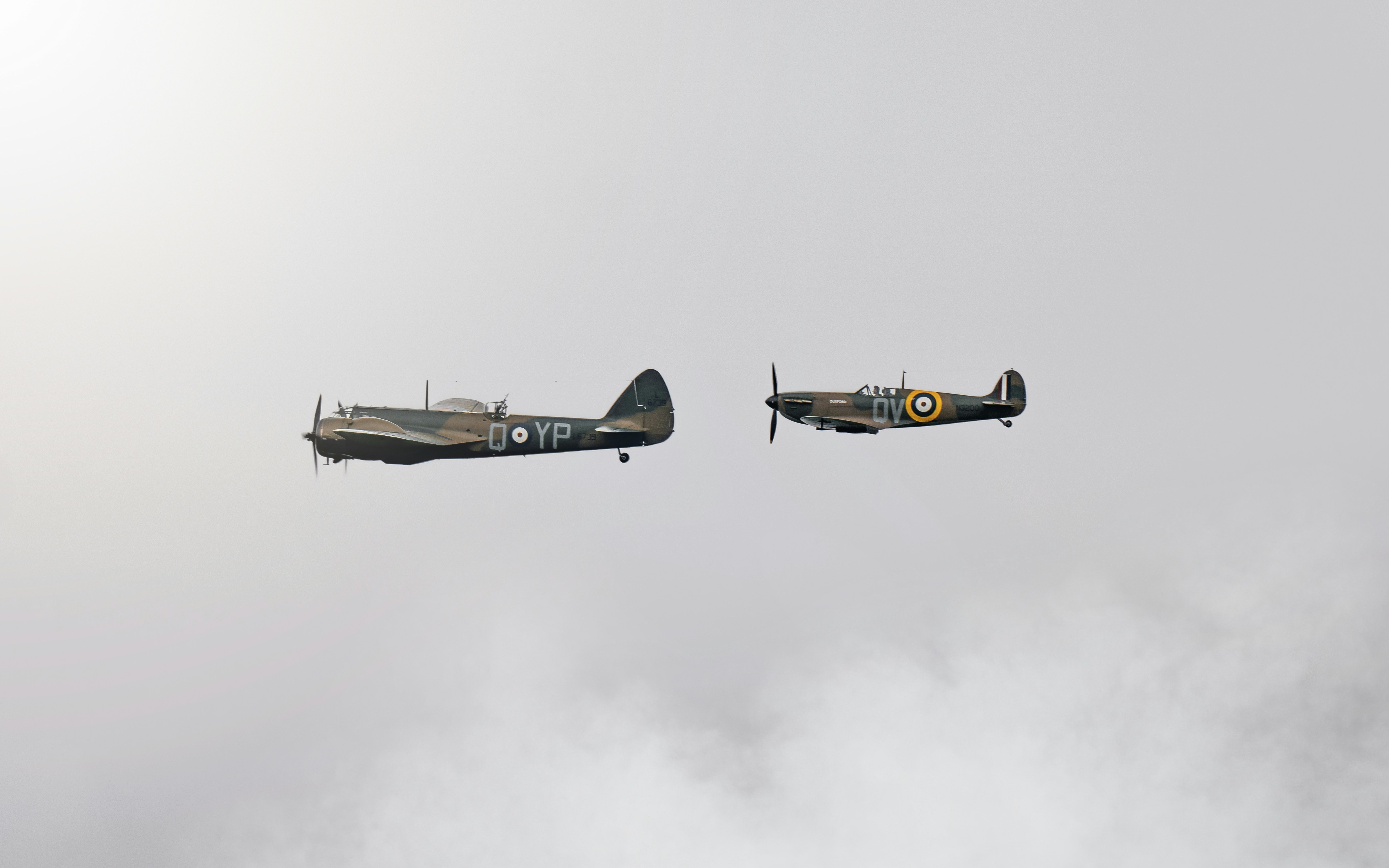 woman wearing yellow long-sleeved dress under white clouds and blue sky during daytime