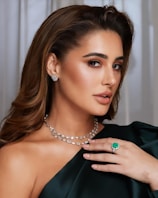 A woman wearing a green dress and a necklace