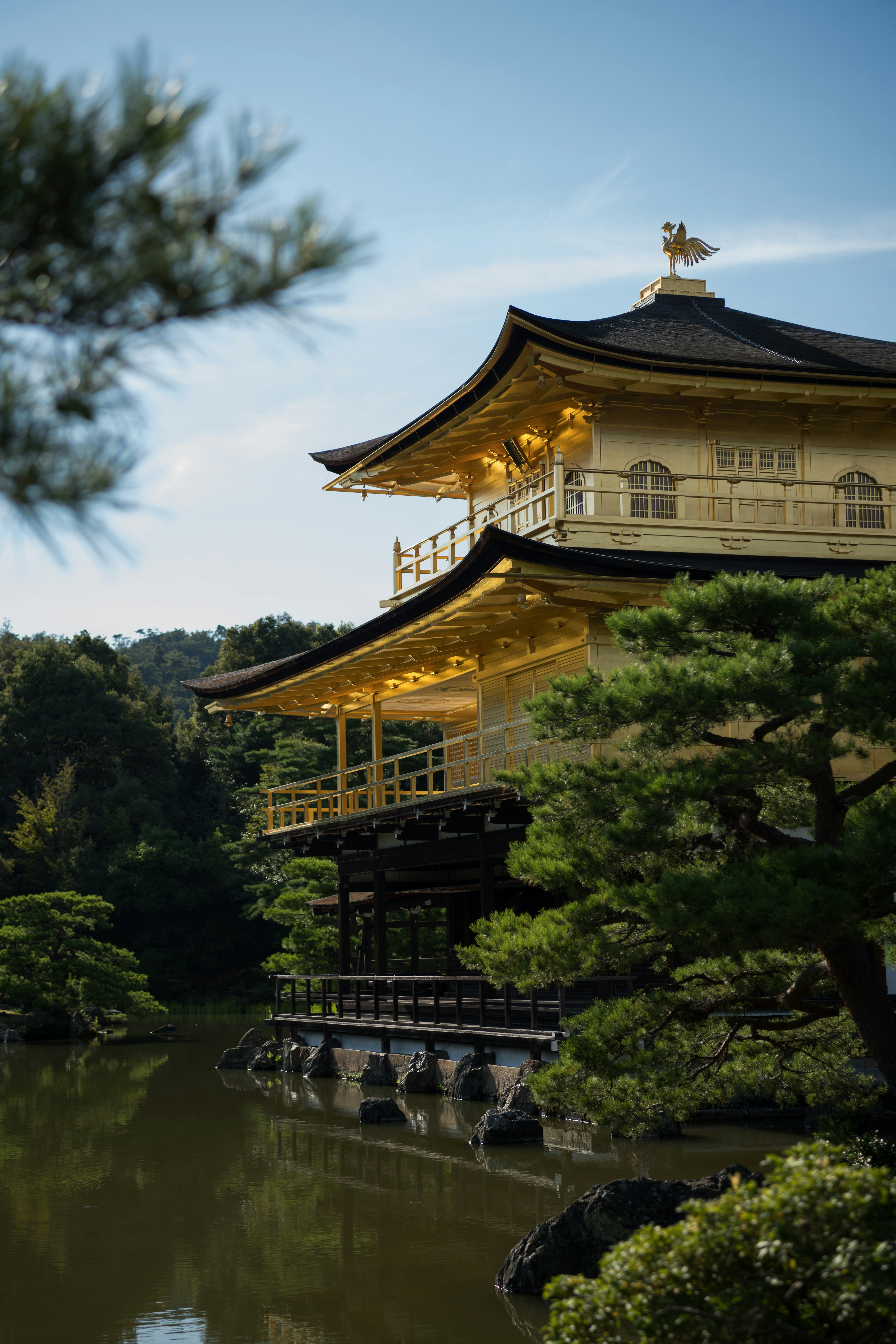 A pagoda in the middle of a lake surrounded by trees