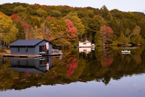 Start your property search banner, featuring calm waters and covered boathouses on Kahshe Lake.