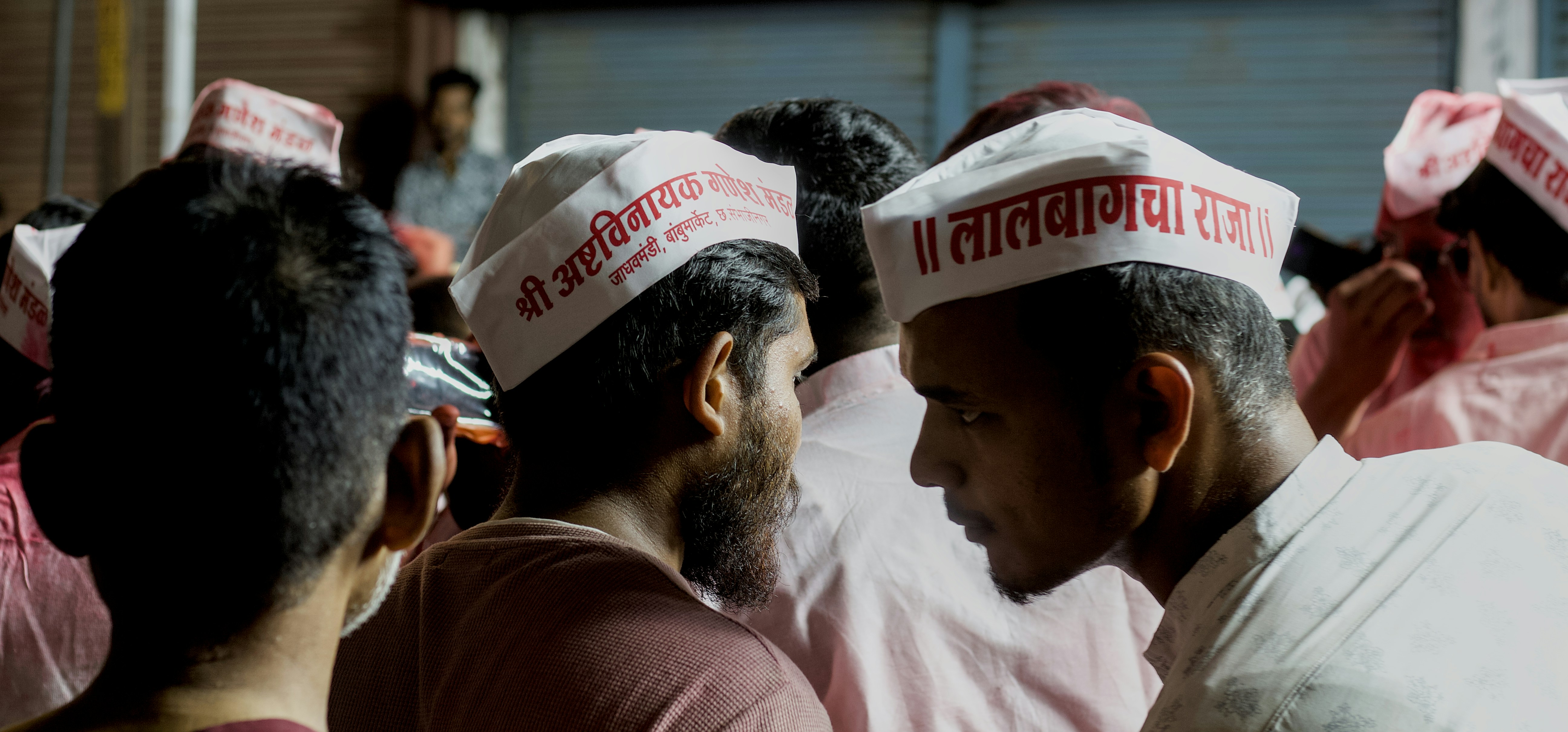 A group of people wearing pink and white hats