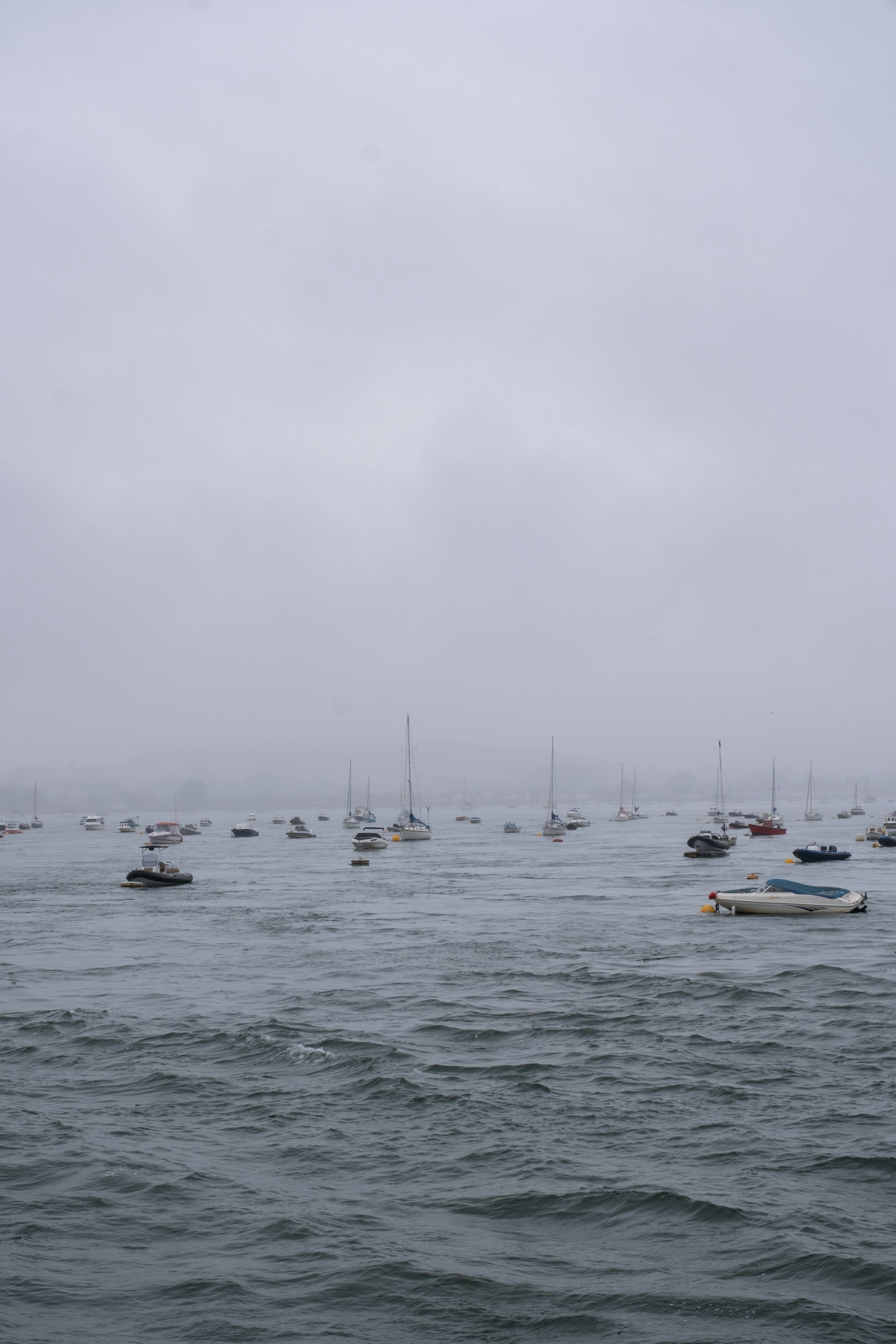 A group of boats floating on top of a body of water