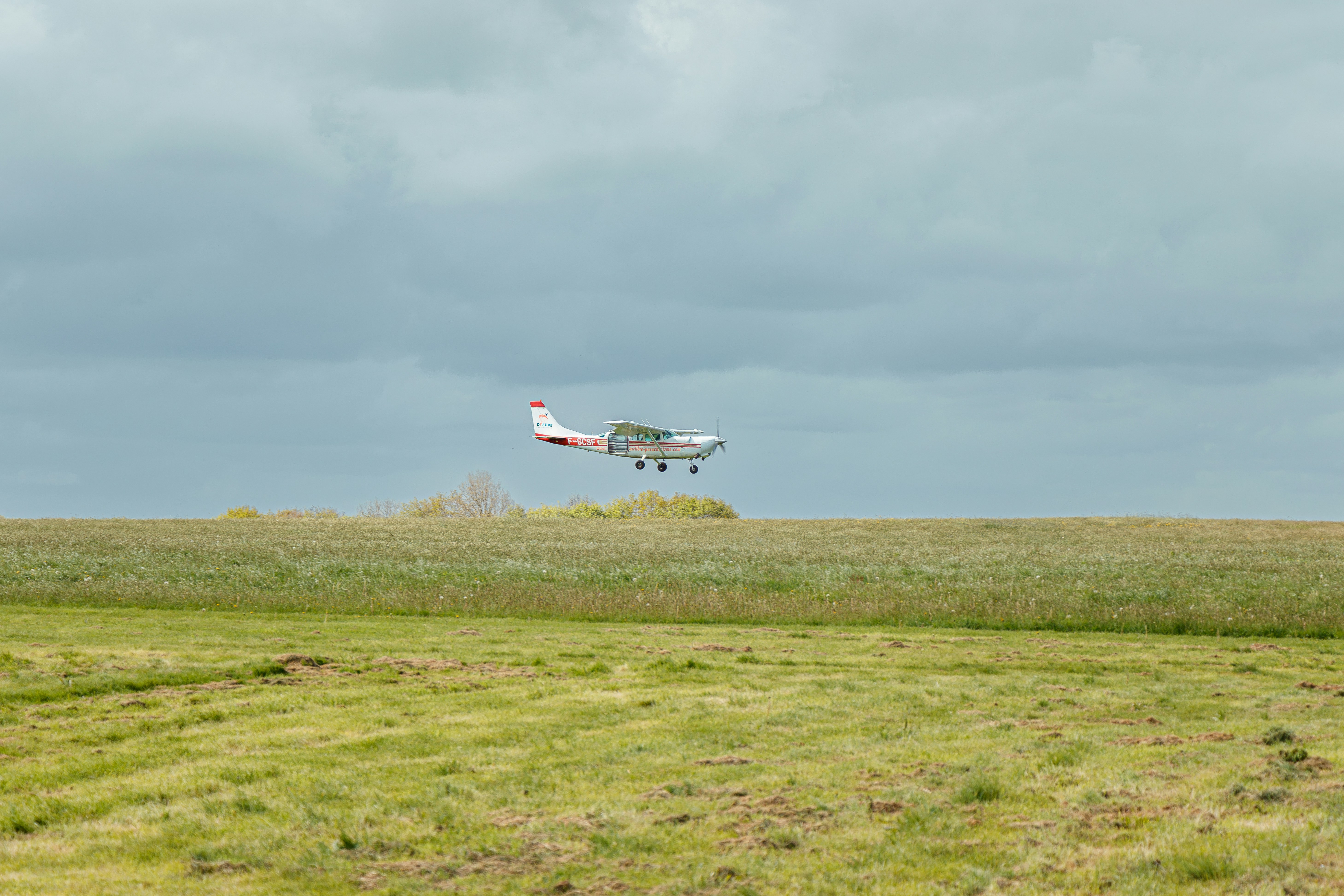 FPV quadcopter being deployed from a transport aircraft cargo ramp during an aerial test.