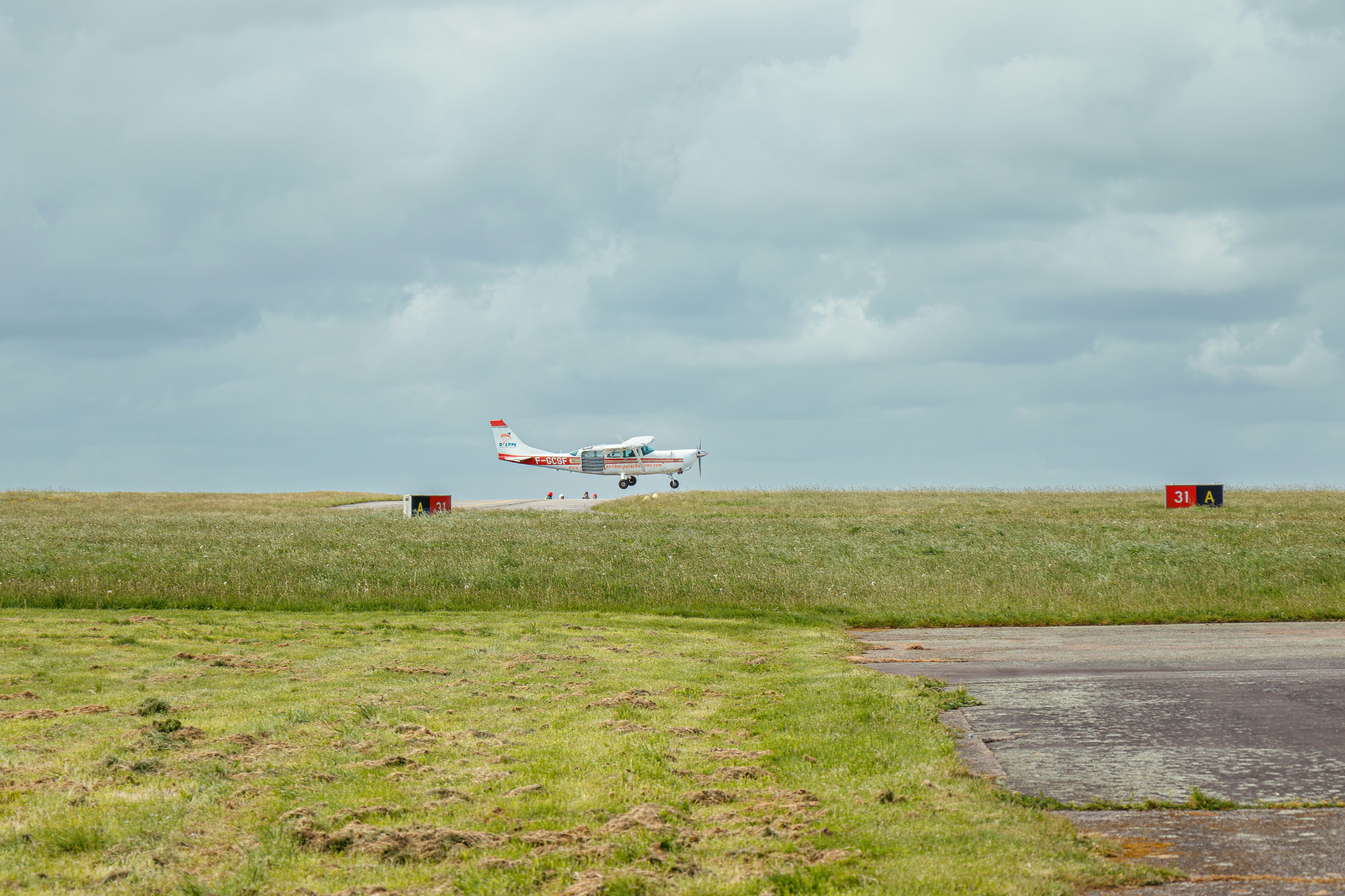 A small plane is taking off from a runway