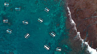 A group of boats floating on top of a body of water