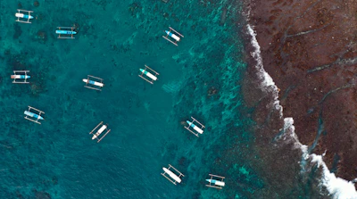 A group of boats floating on top of a body of water