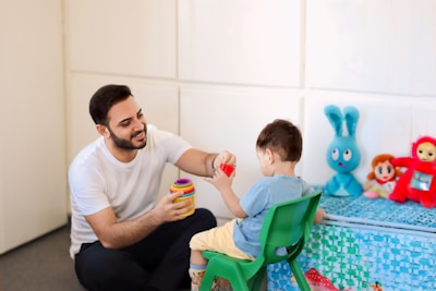 A man is playing with a child in a room