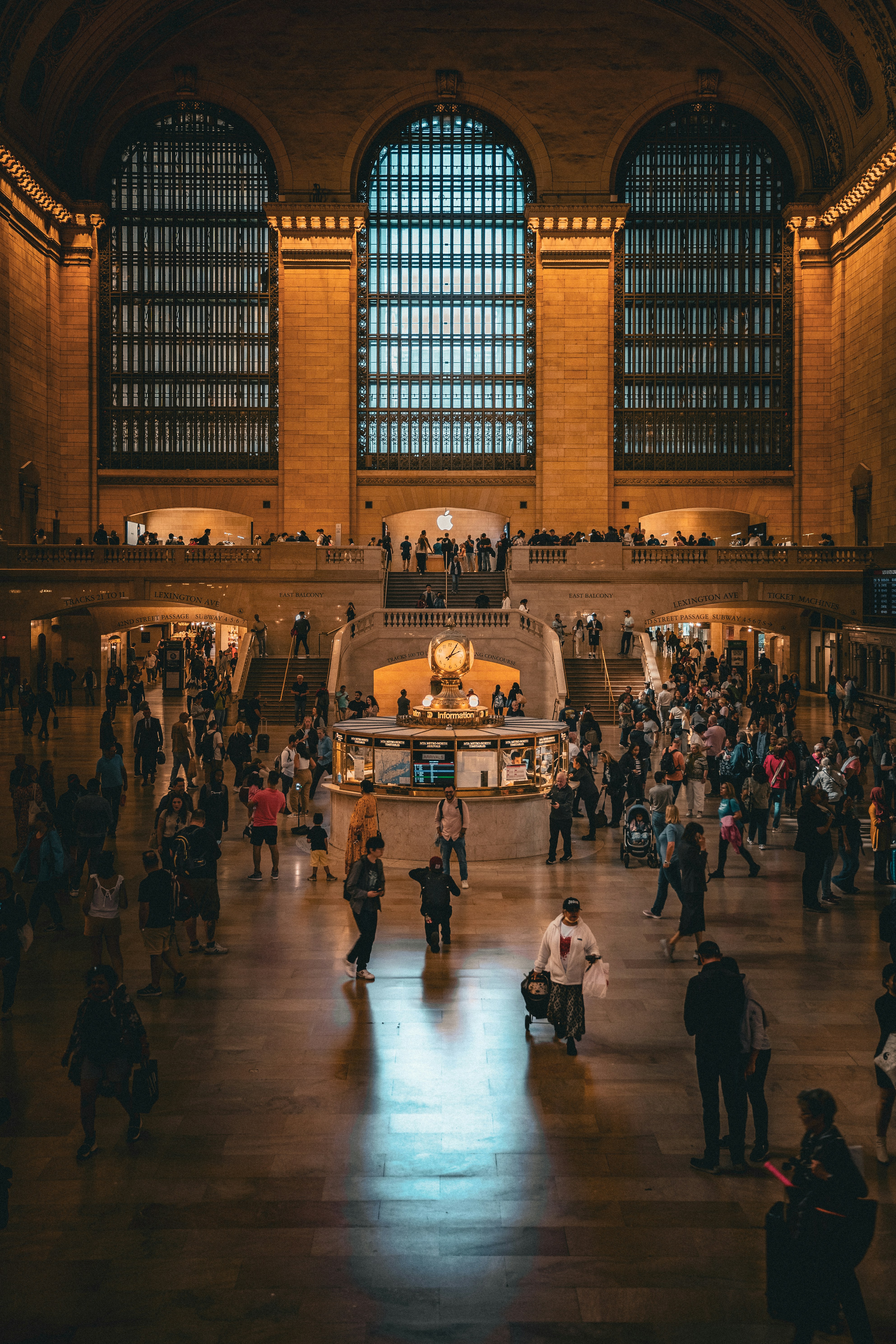 A group of people standing around a train station