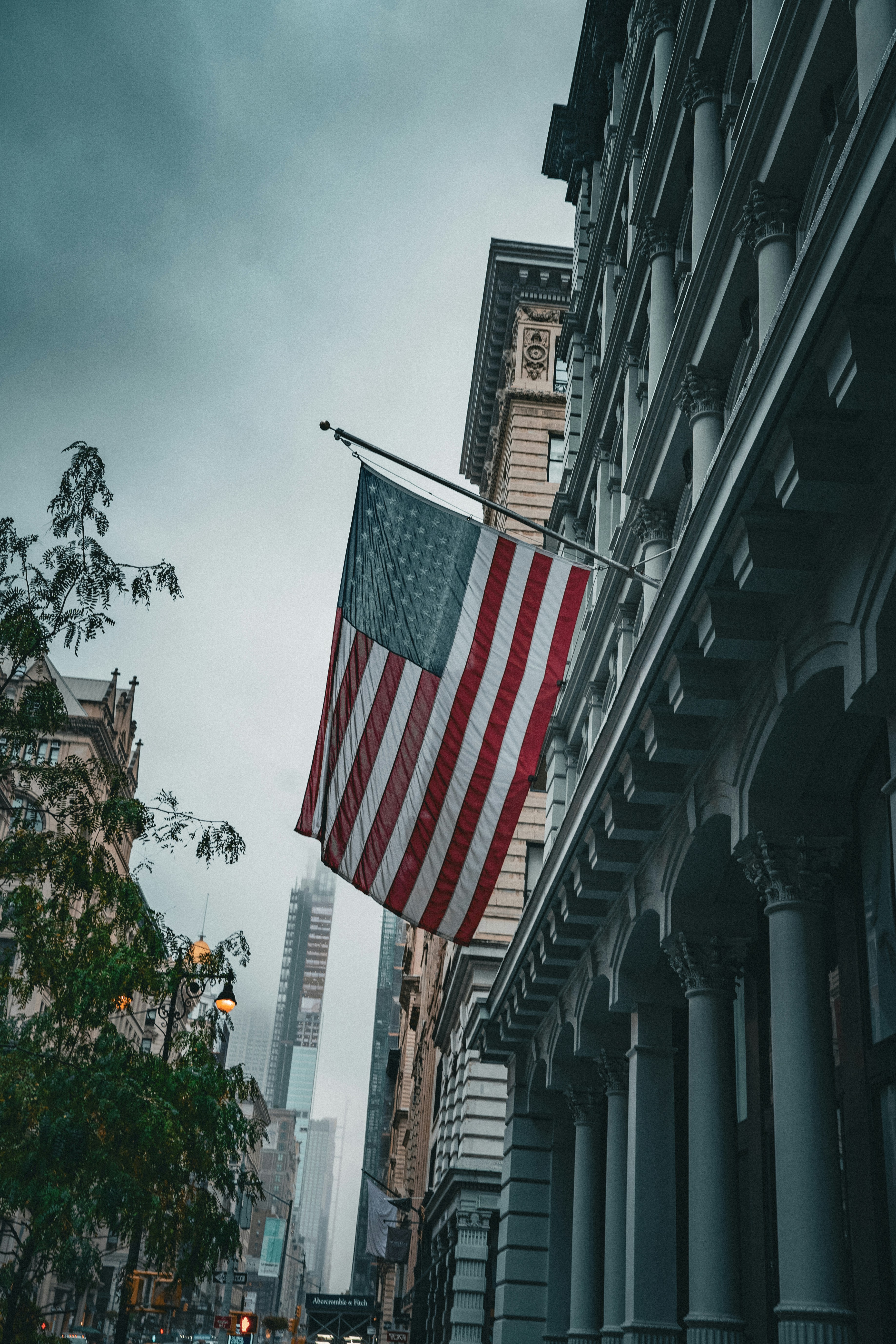An american flag hanging from the side of a building