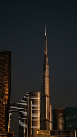 A very tall building towering over a city