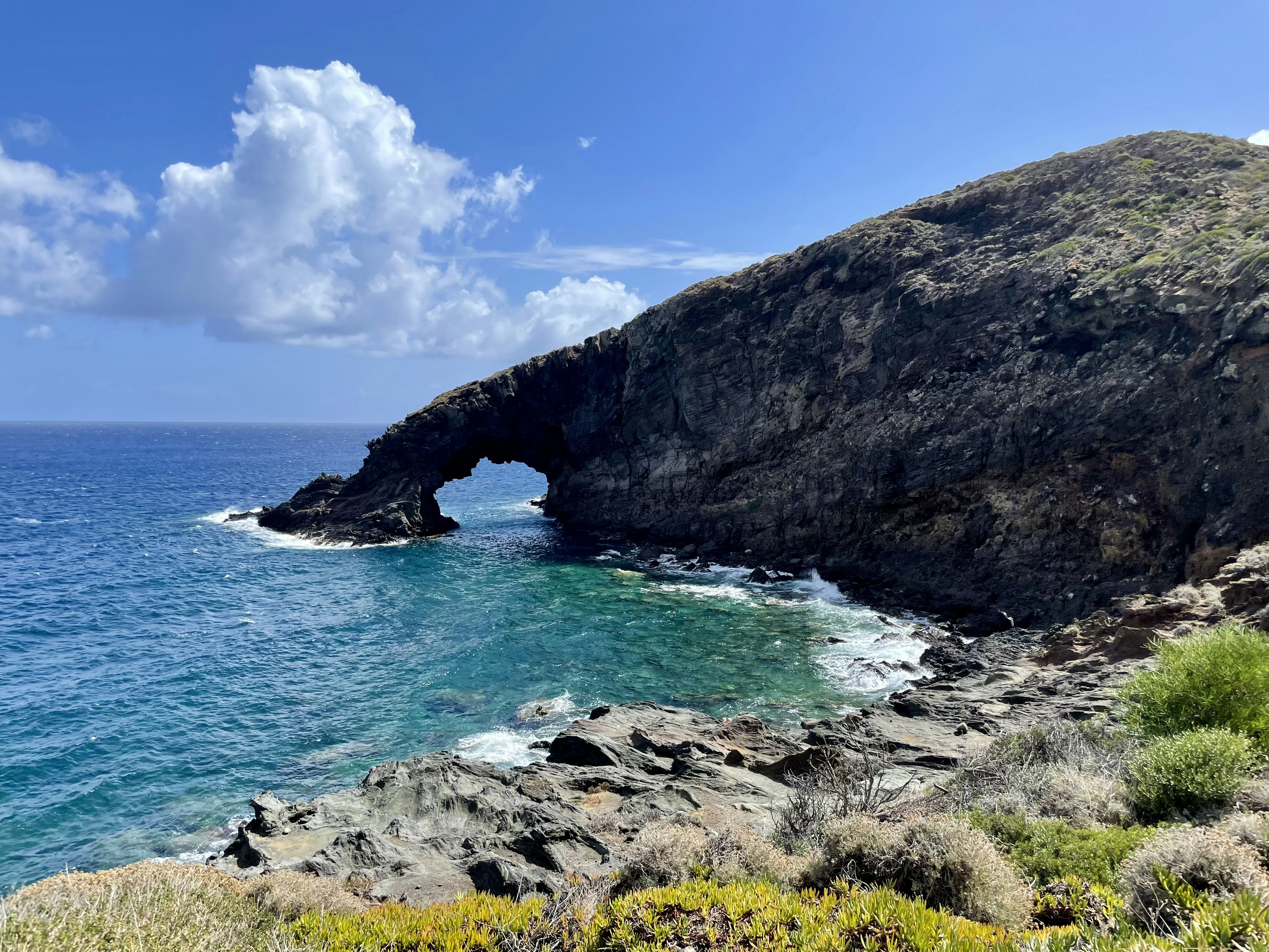 A rocky cliff overlooks a body of water