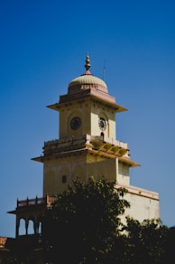 A tall tower with a clock on the top of it