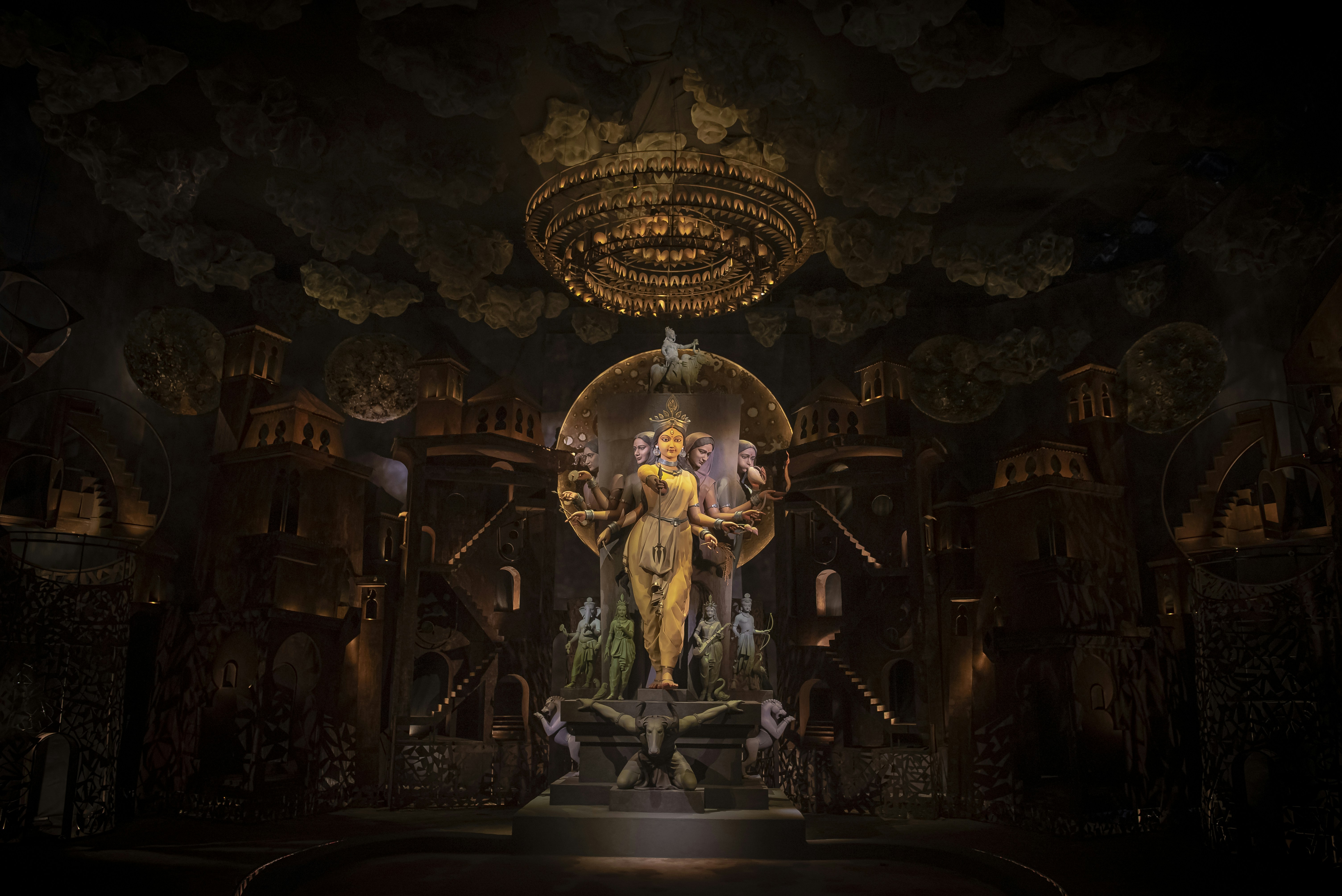 A dark room with a statue of a woman on a throne
