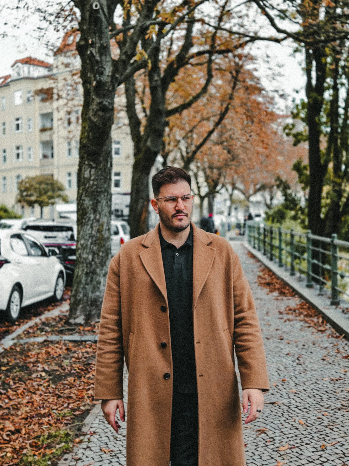 Man in a coat walking outdoors on a cool autumn morning, illustrating seasonal changes in testosterone levels.