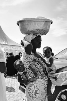 A woman carrying a child on her head