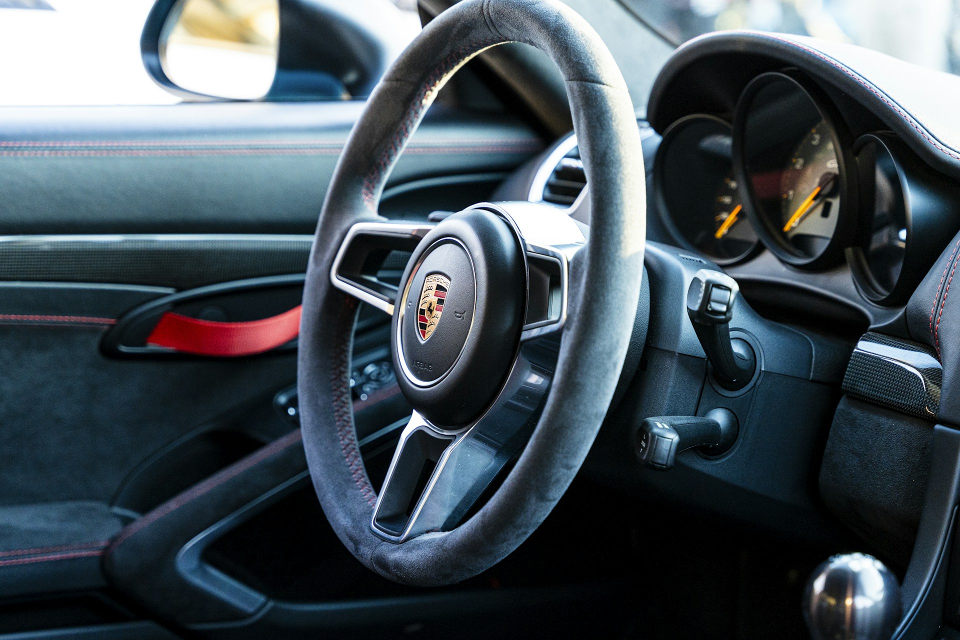 A close up of a steering wheel and dashboard of a car