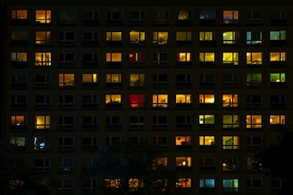 A building with many windows lit up at night