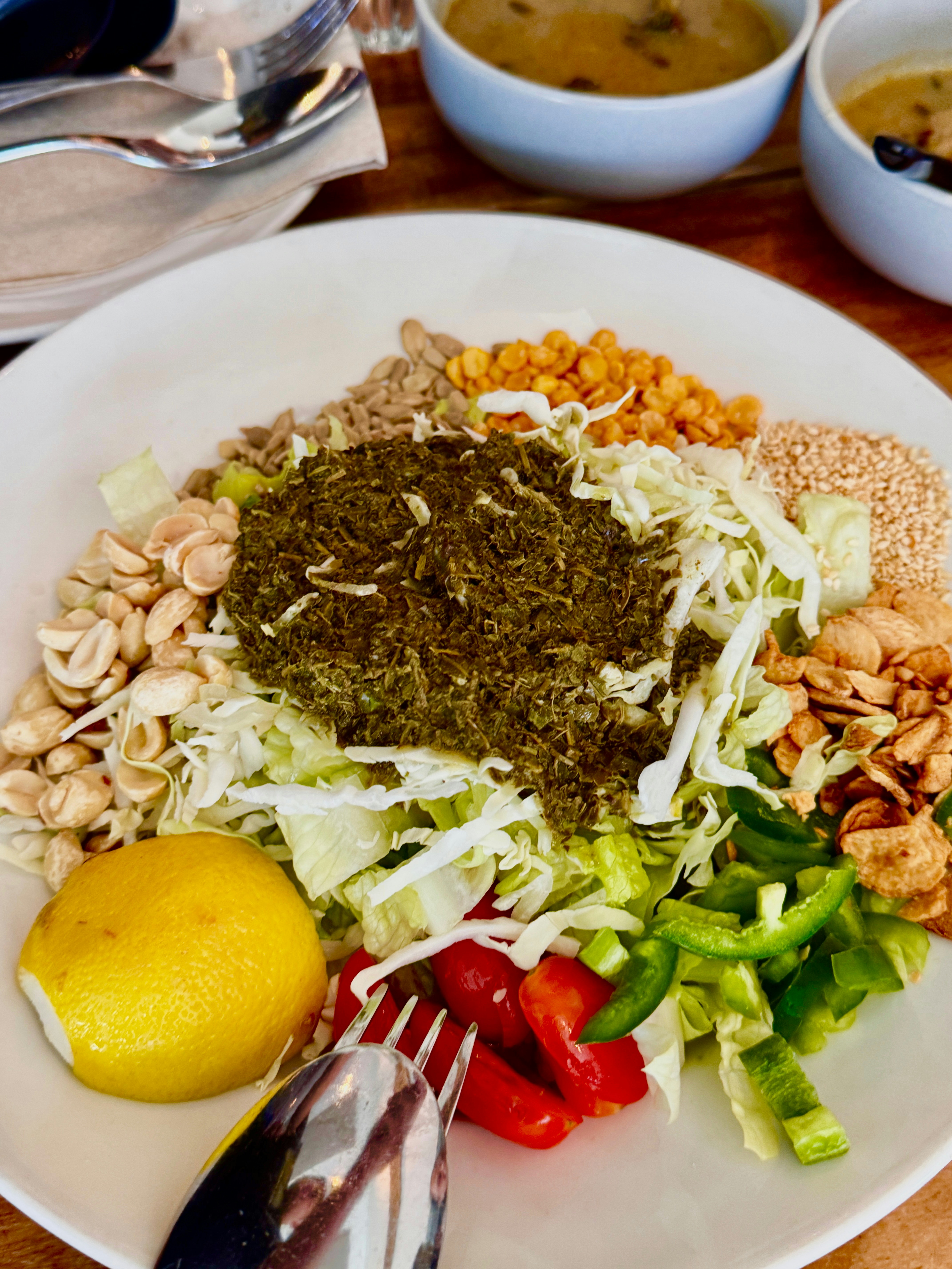 Assiette colorée de légumes verts frais et graines sur fond blanc lumineux