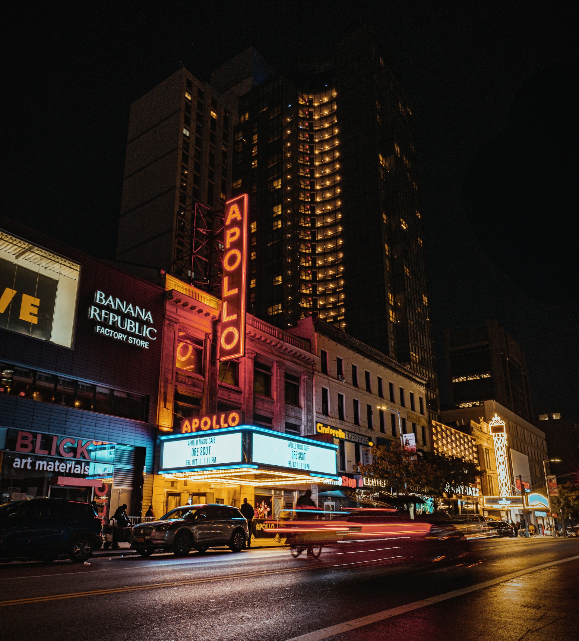 A city street at night with a lot of traffic