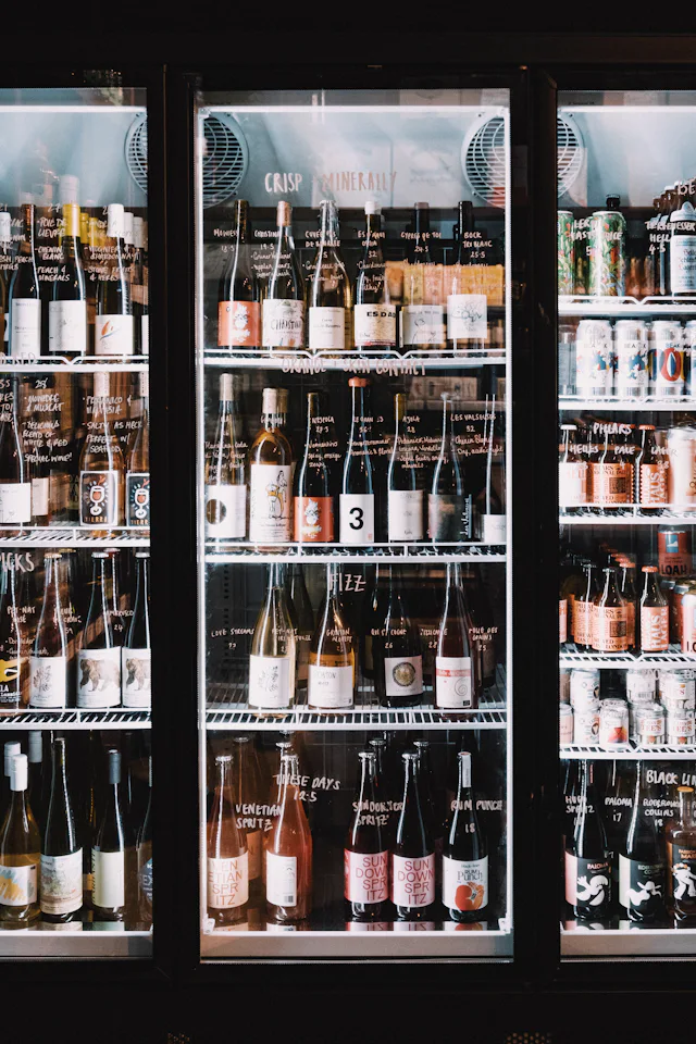 Wine cooler refrigerator filled with bottles, the type of unit we repair in Somerville