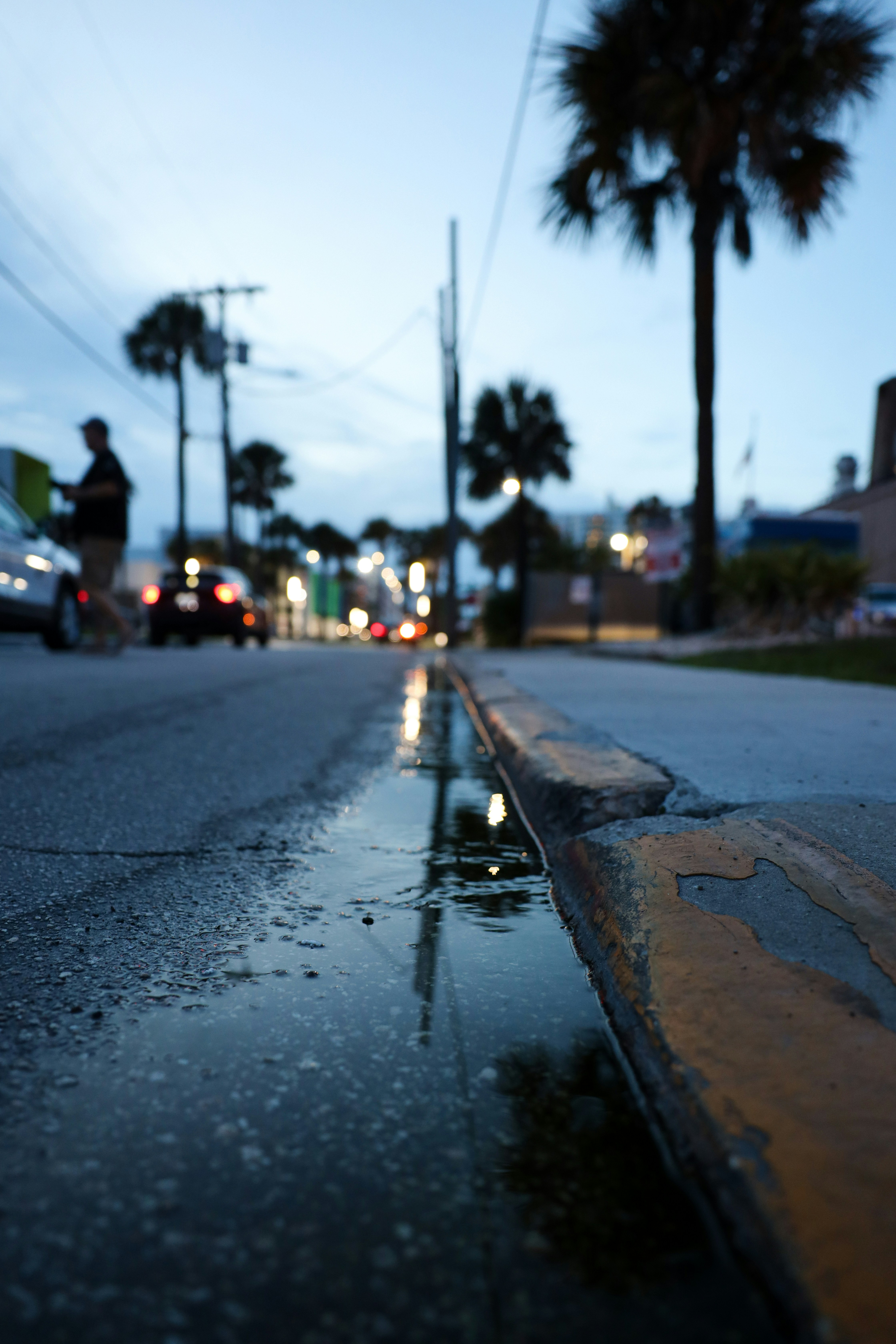 A street with a puddle of water on the side of it