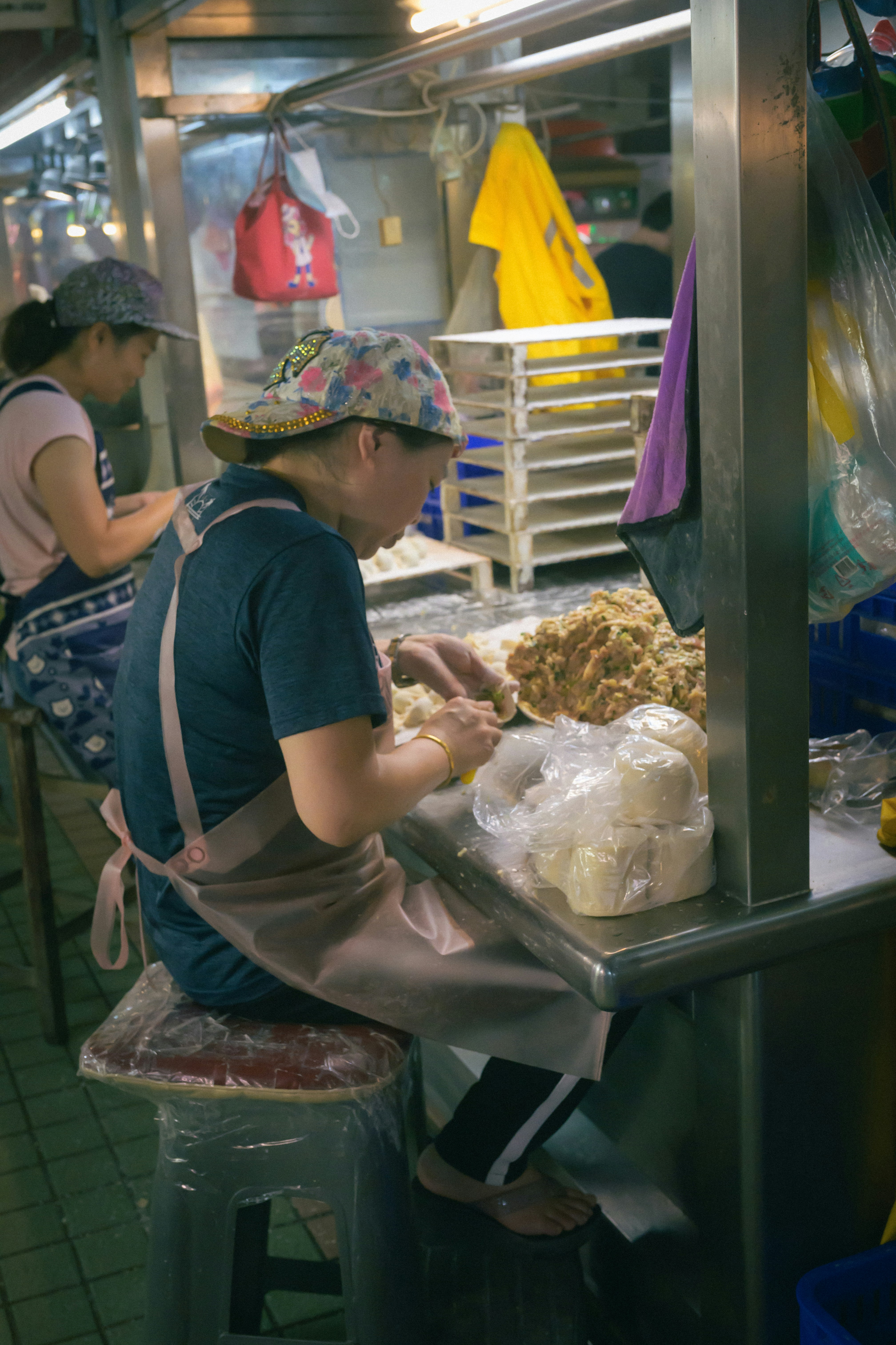 A woman working in a kitchen preparing food