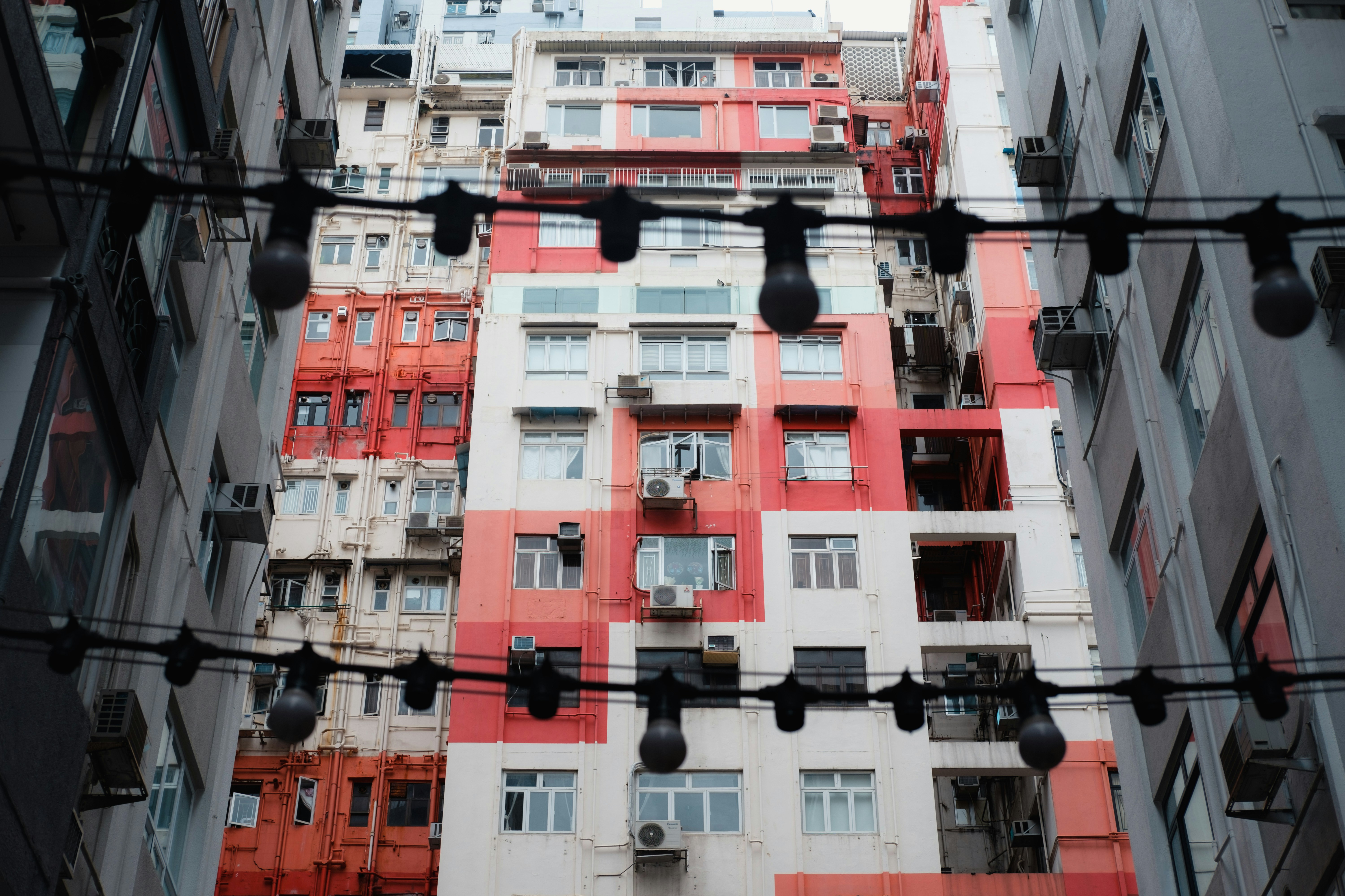 A tall red and white building with lots of windows