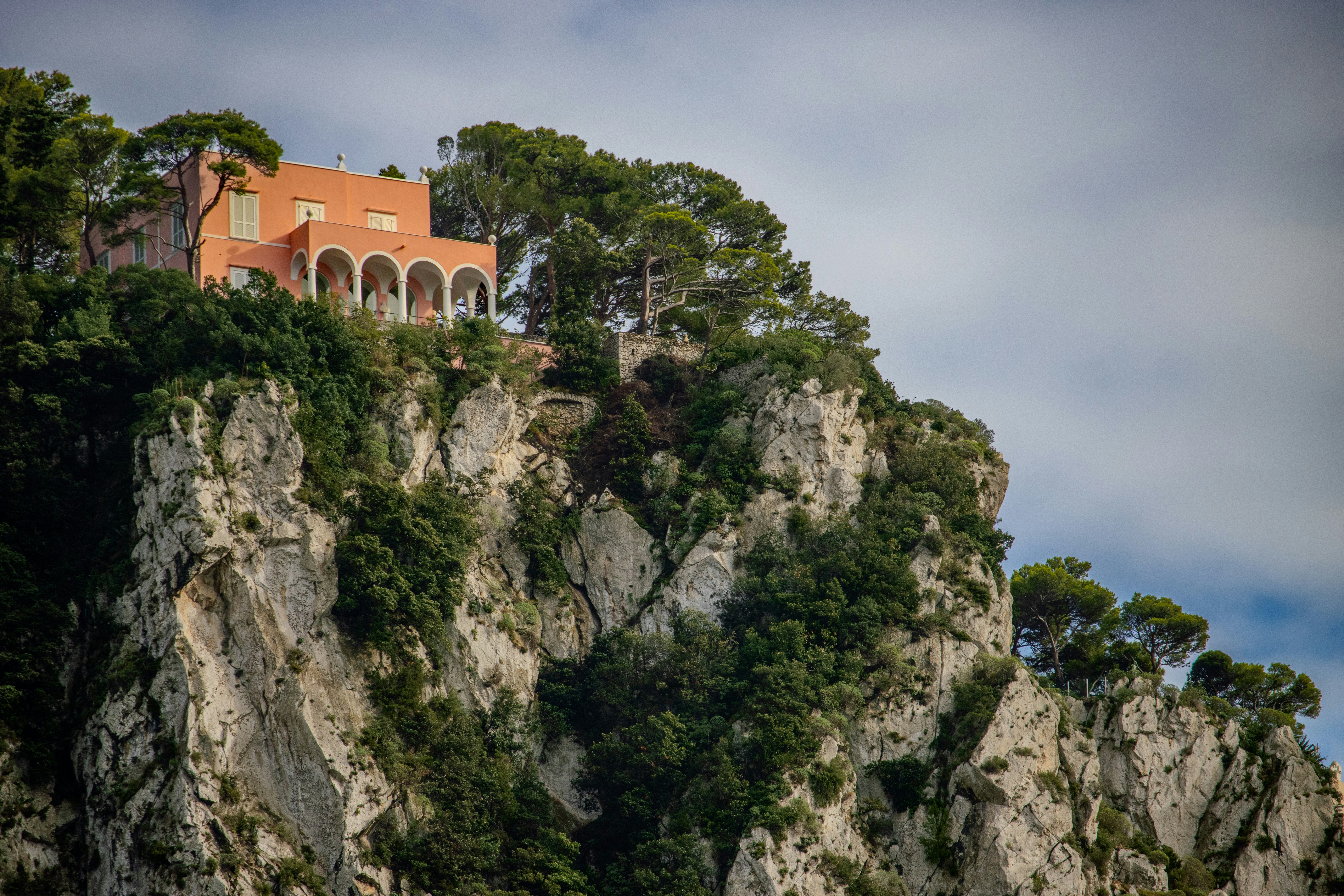 A house on top of a mountain surrounded by trees