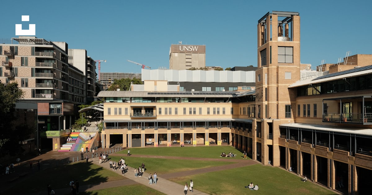 A large building with a clock tower in the middle of it photo – Free ...
