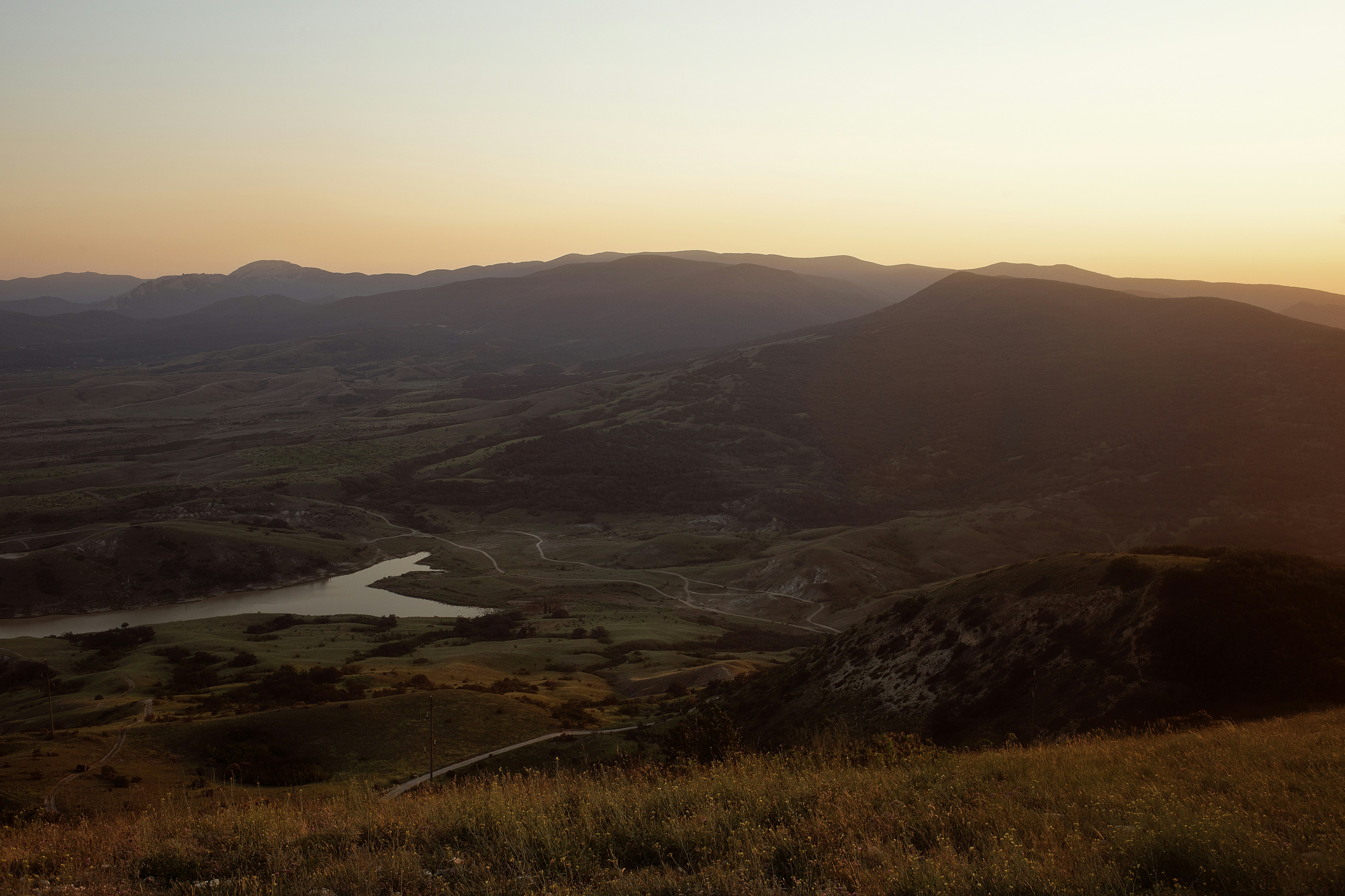 The sun is setting over a mountain range