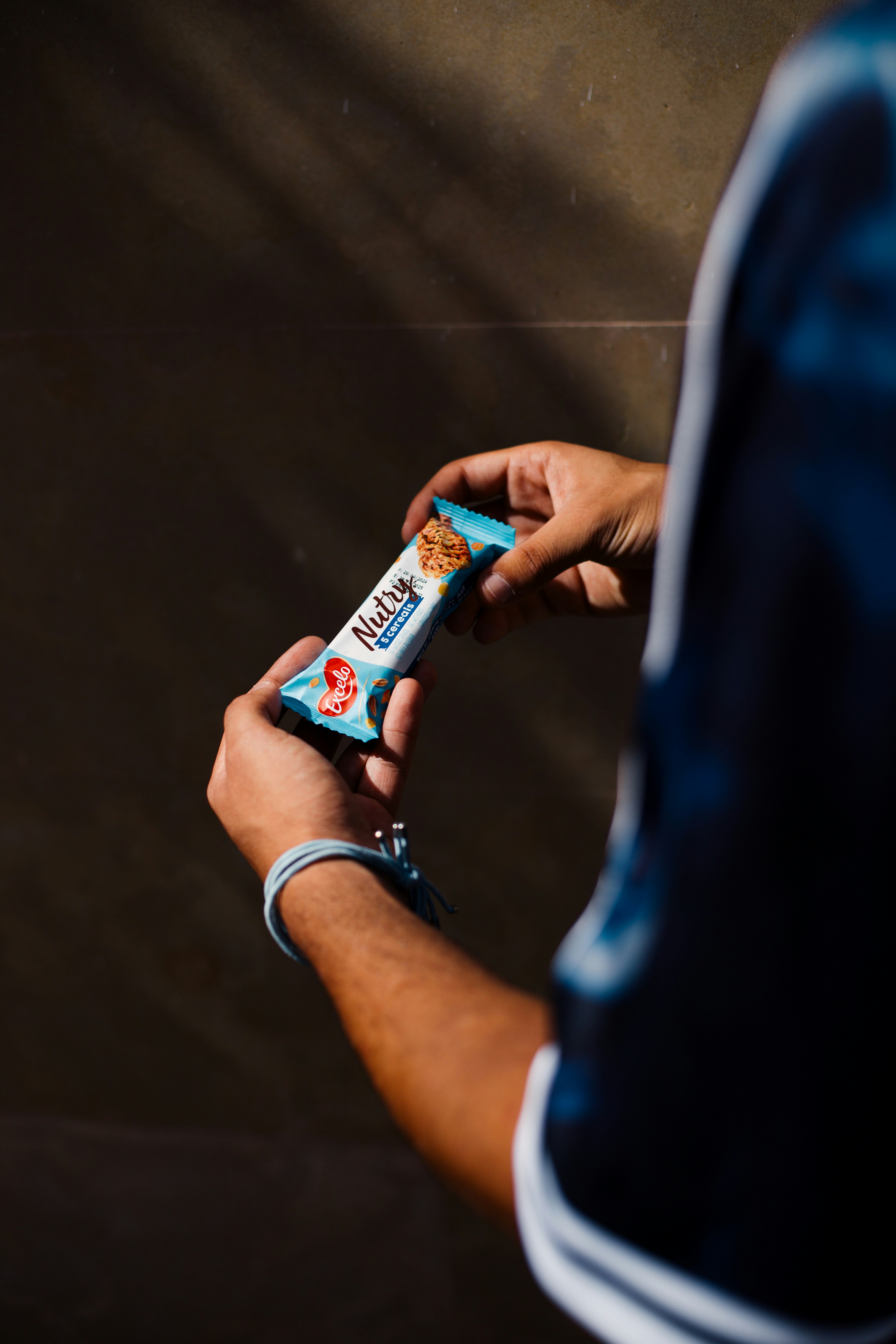 A man holding a tube of toothpaste in his hand